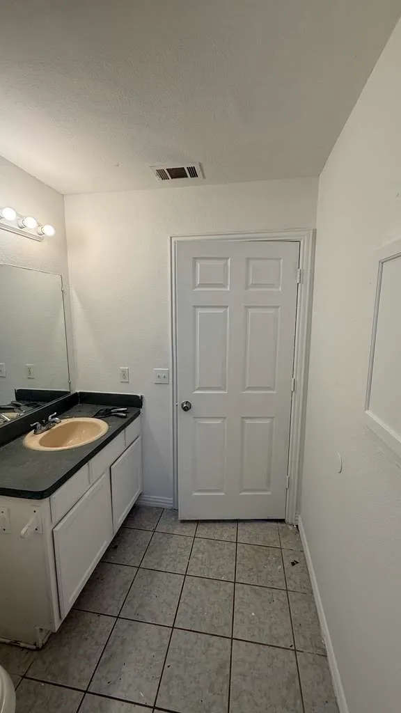 Bathroom with vanity and light tile patterned floors