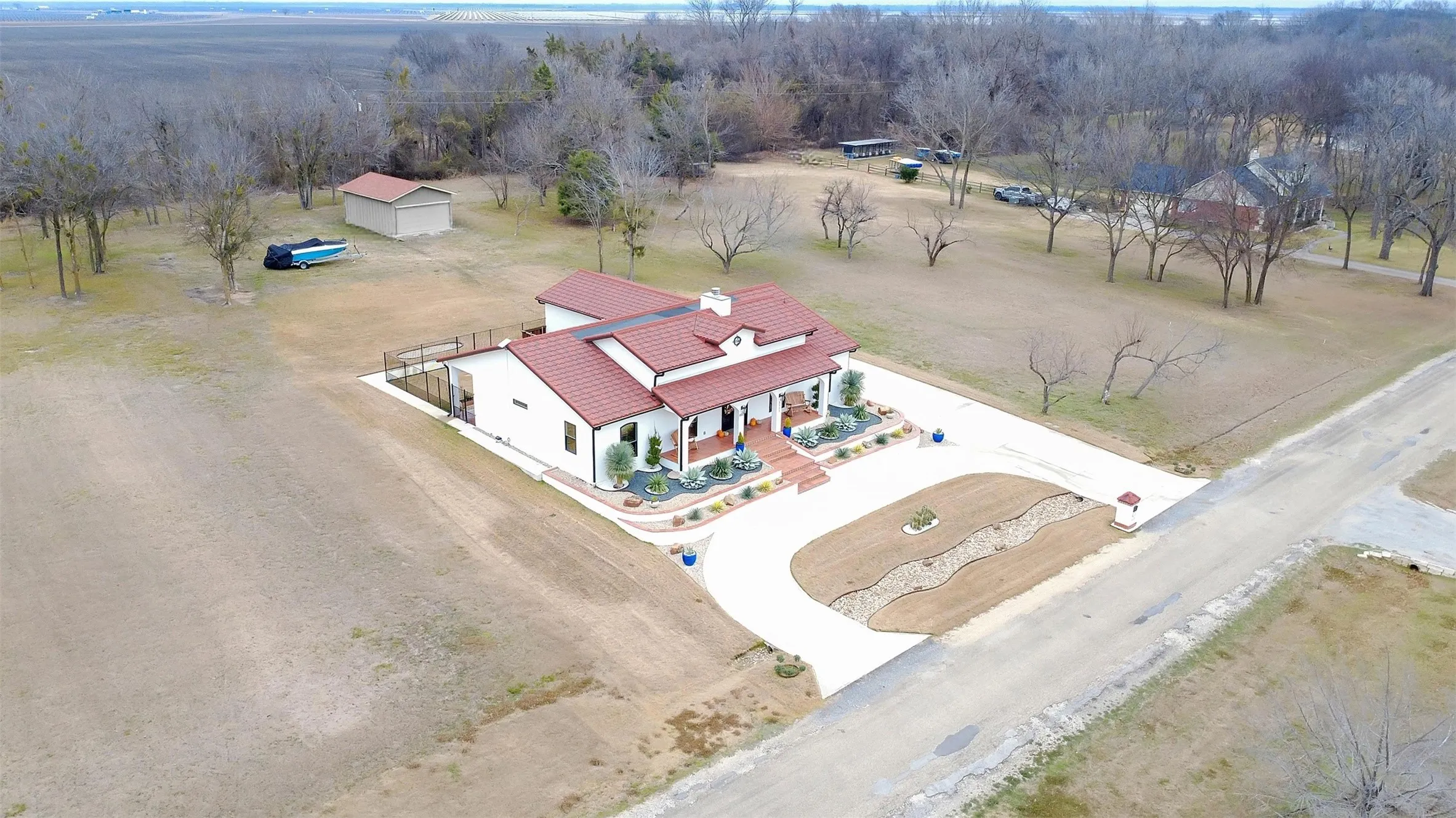 AERIAL VIEW OF THE PROPERTY WITH THE STORAGE BUILDING.