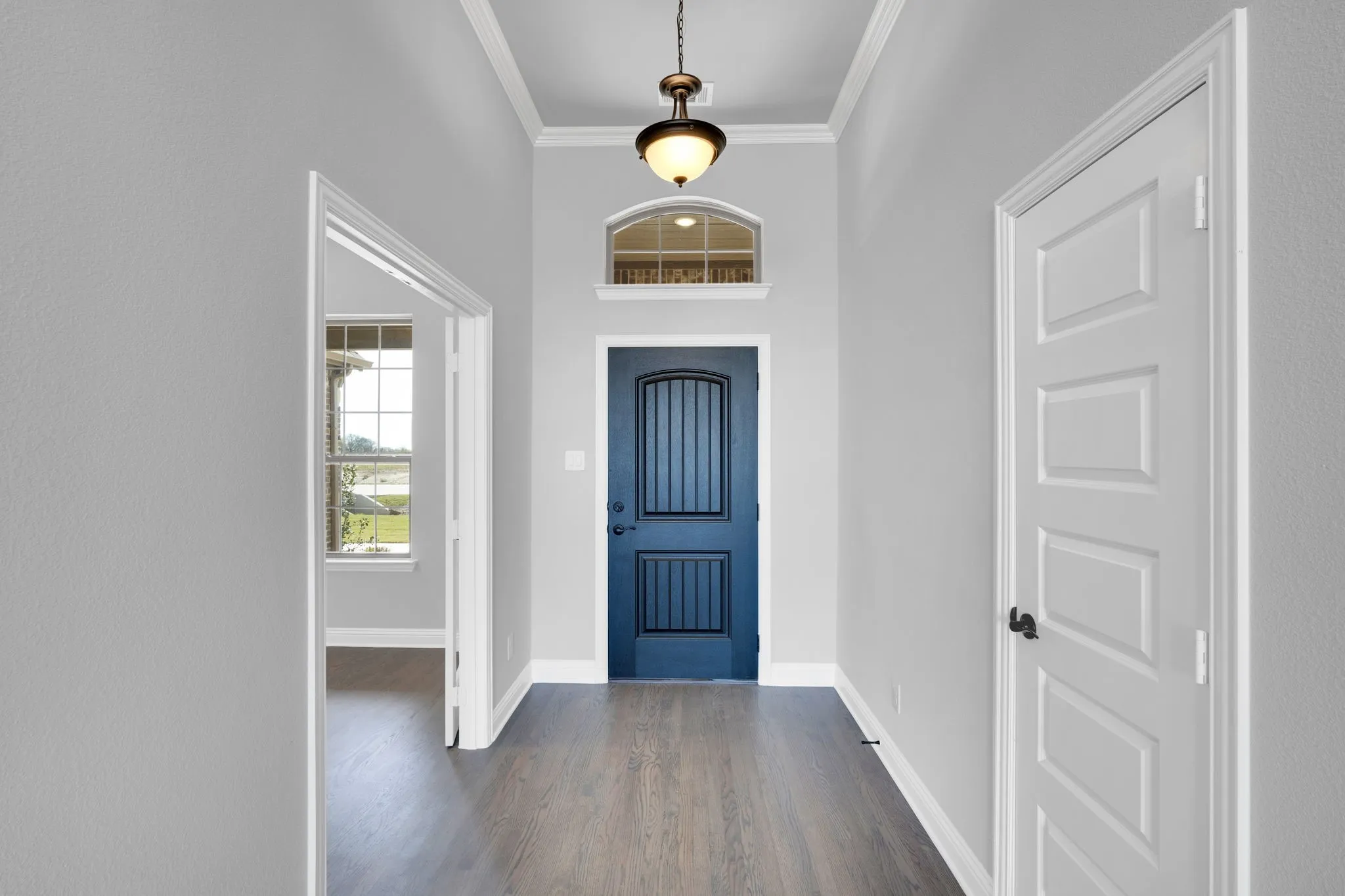 Welcoming entry with elevated ceilings and warm wood flooring.