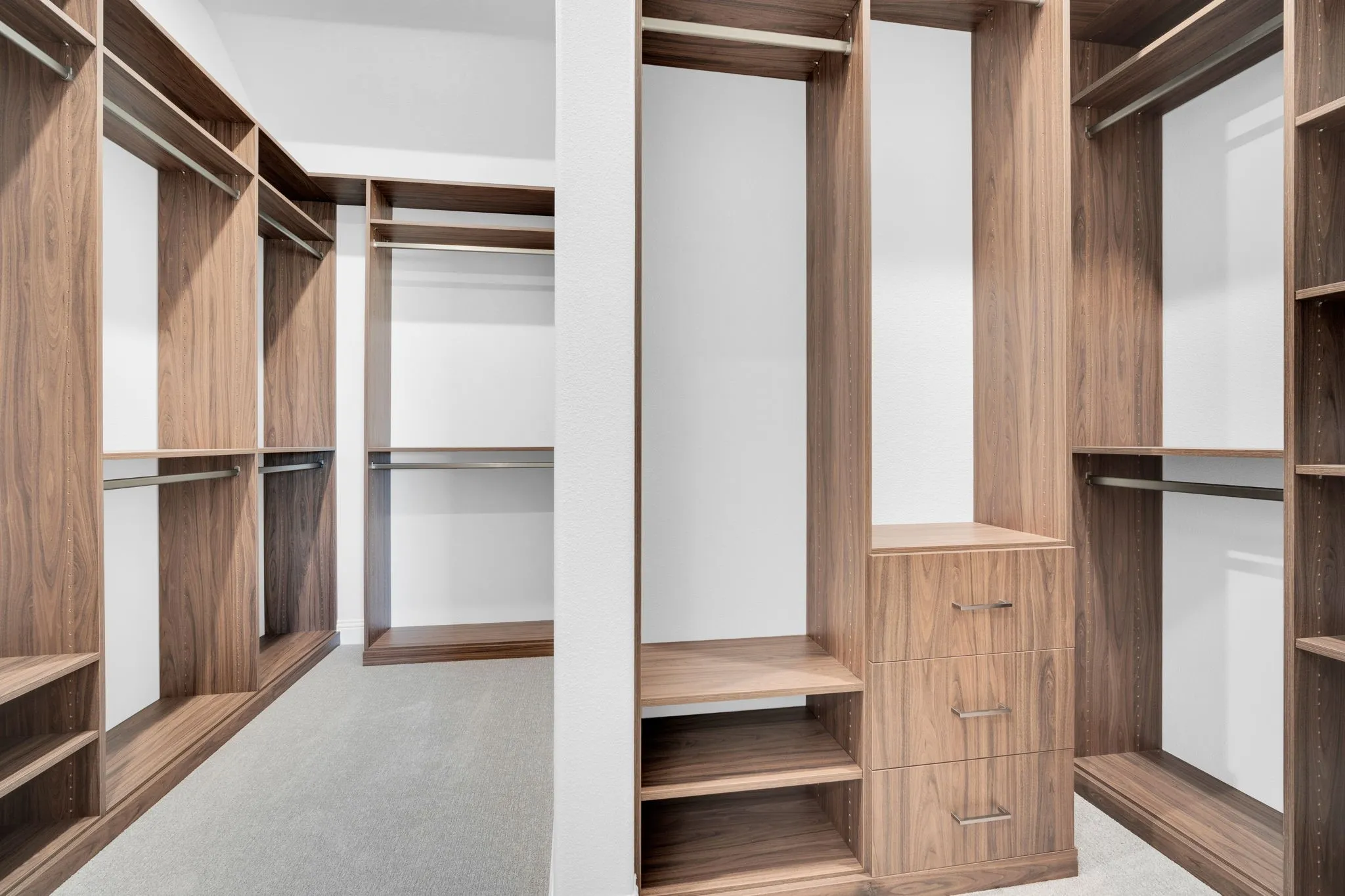 Large walk-in closet with custom built-in storage and organization.