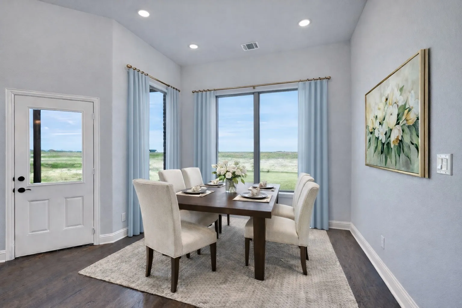 Bright dining space overlooking the backyard and covered patio. Virtually staged