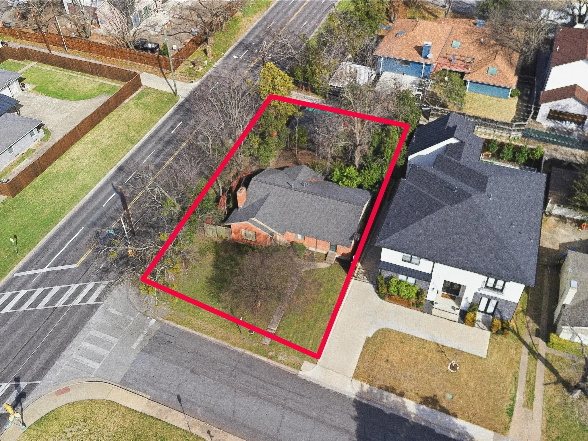 Aerial view of residential area featuring property boundaries highlighted