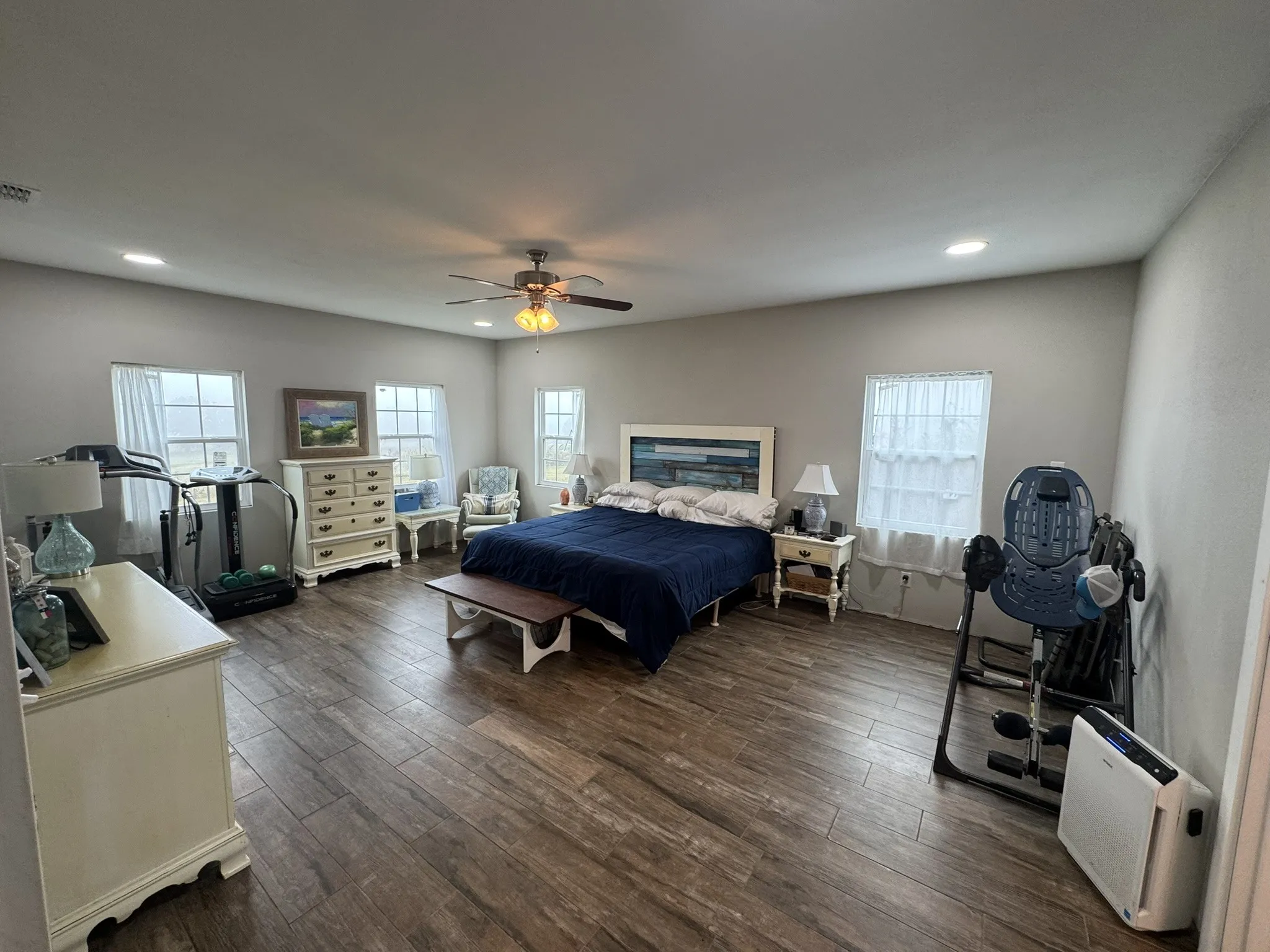 Bedroom featuring multiple windows, dark wood-style floors, a ceiling fan, and recessed lighting