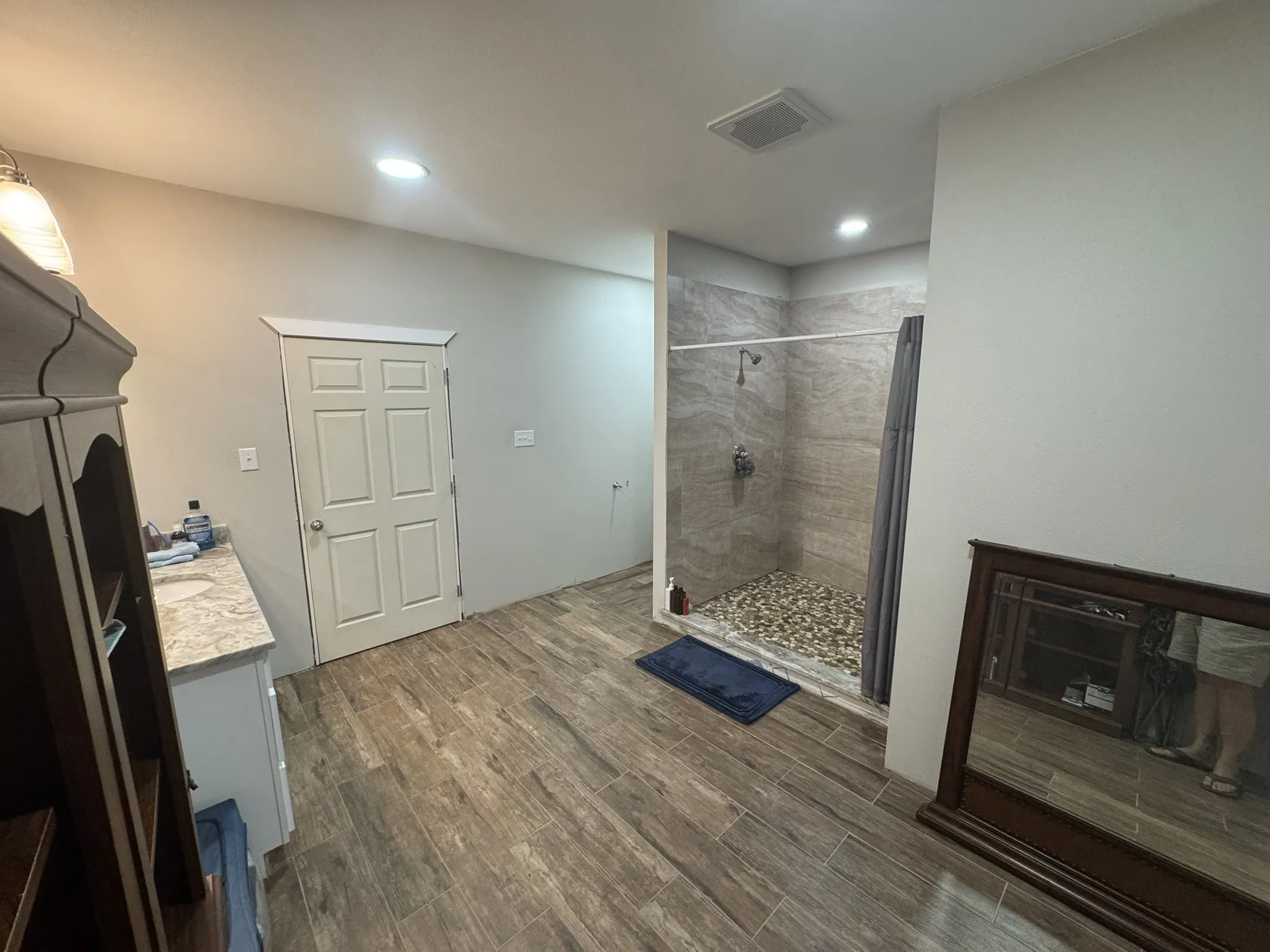 Bathroom featuring vanity, dark wood finished floors, a shower stall, and recessed lighting