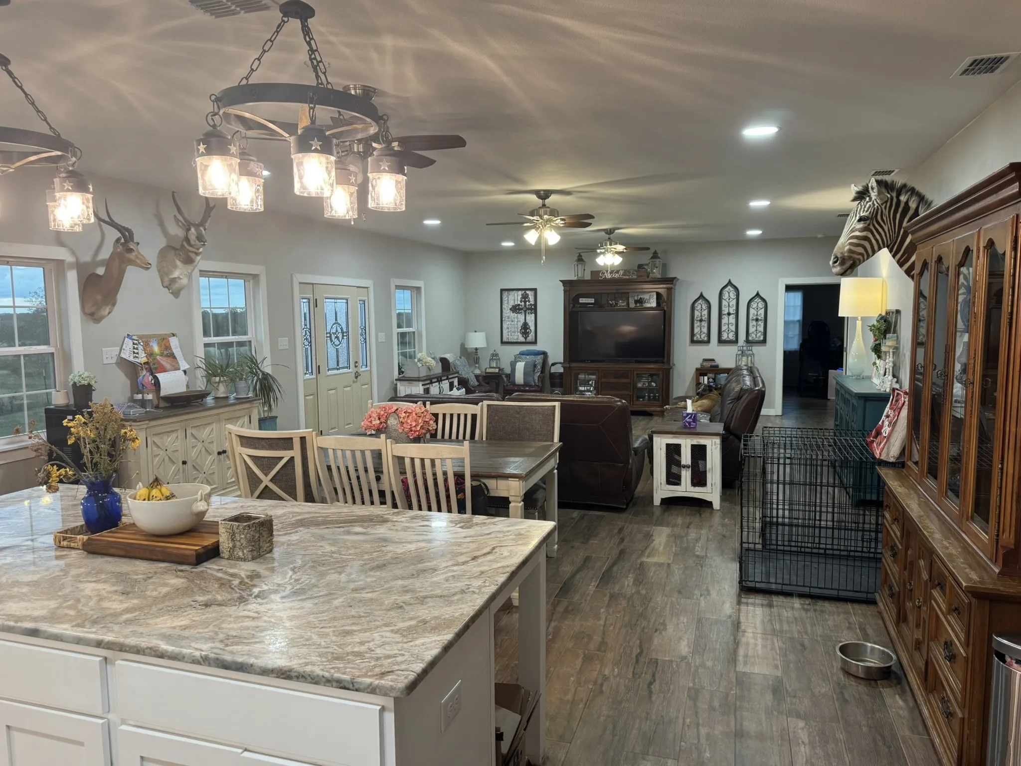 Kitchen featuring dark wood-type flooring, recessed lighting, white cabinetry, decorative light fixtures, and open floor plan