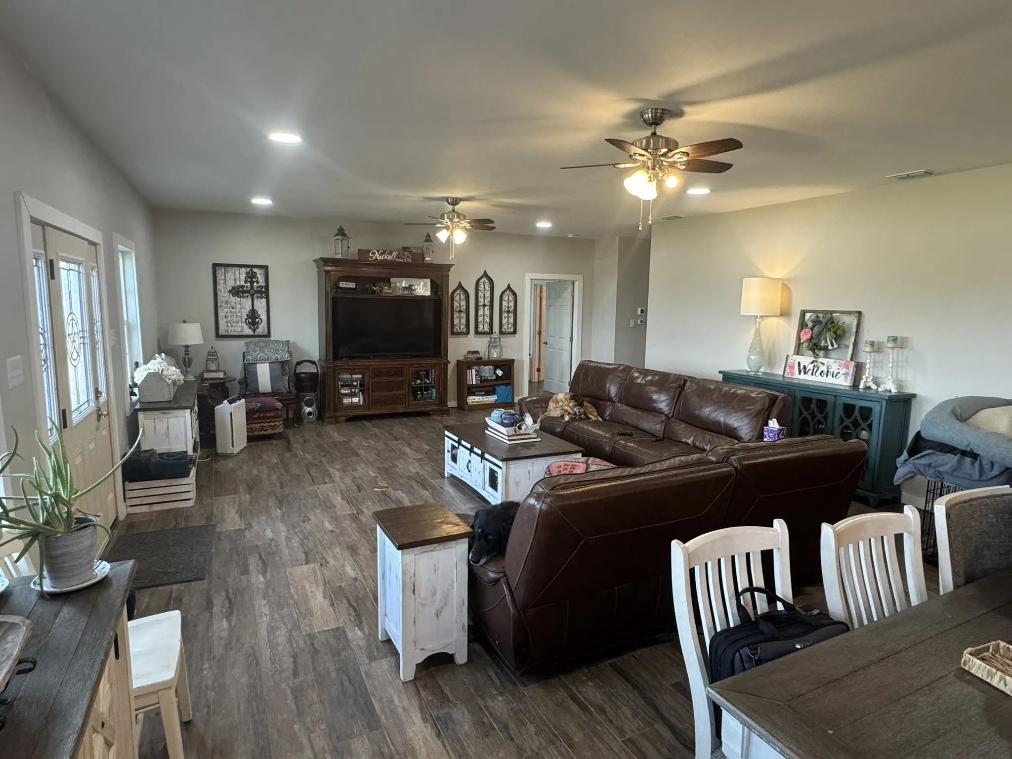 Living room with wood finished floors, recessed lighting, and ceiling fan