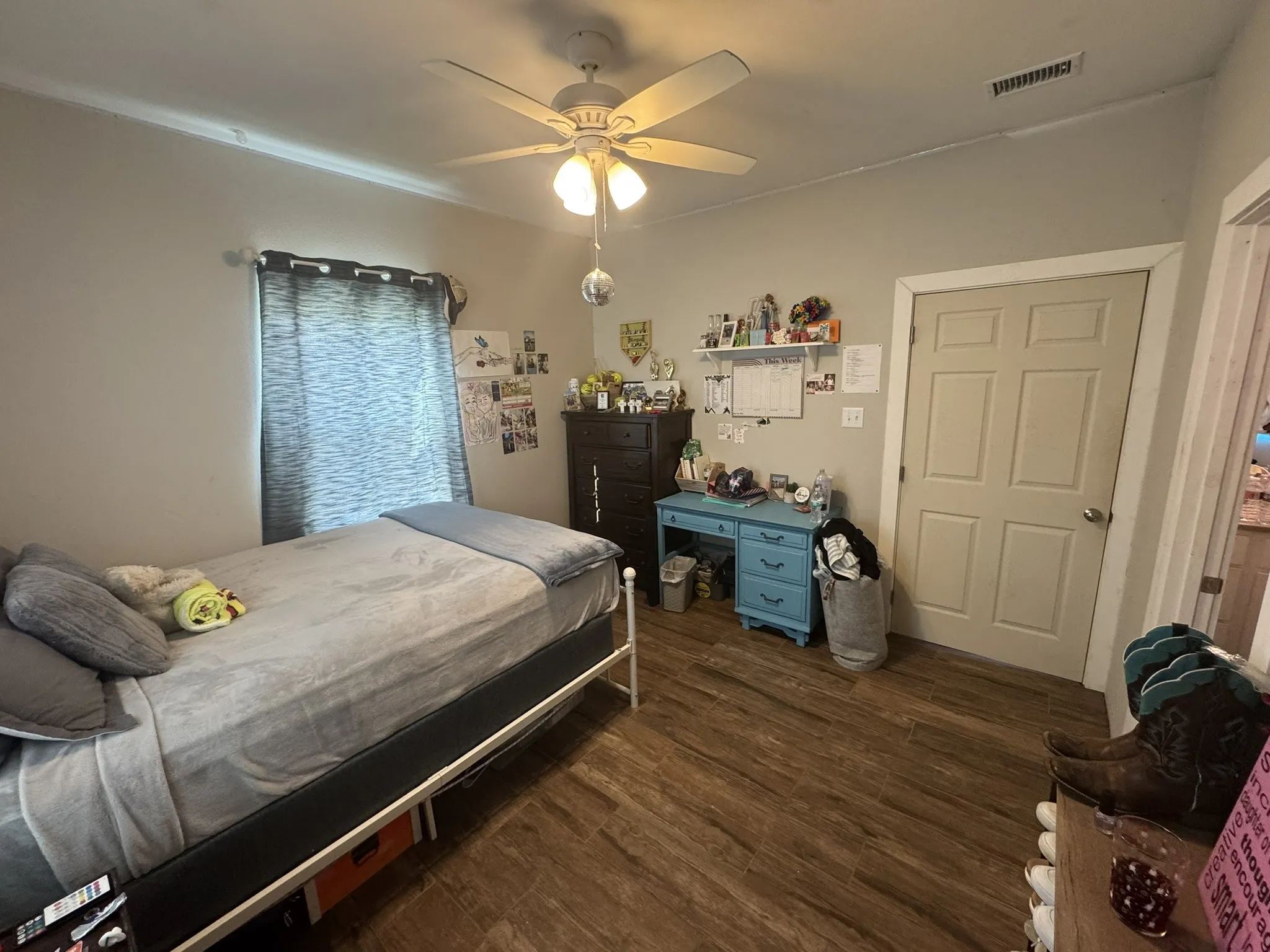 Bedroom with dark wood-style flooring and ceiling fan
