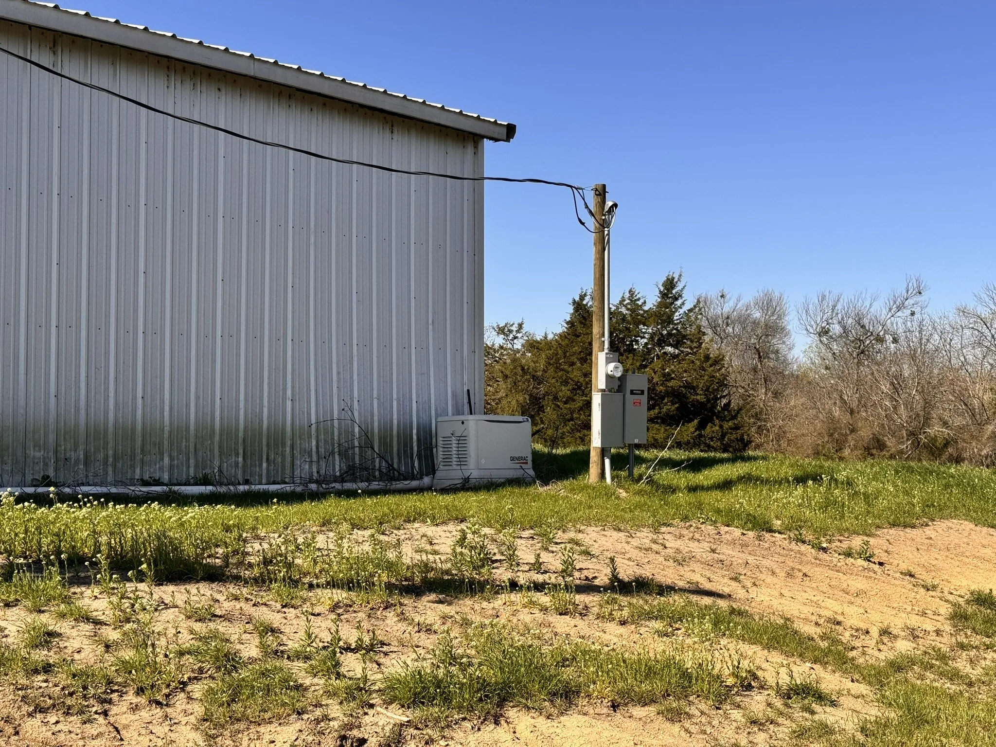 View of side of home with an outbuilding and metal roof