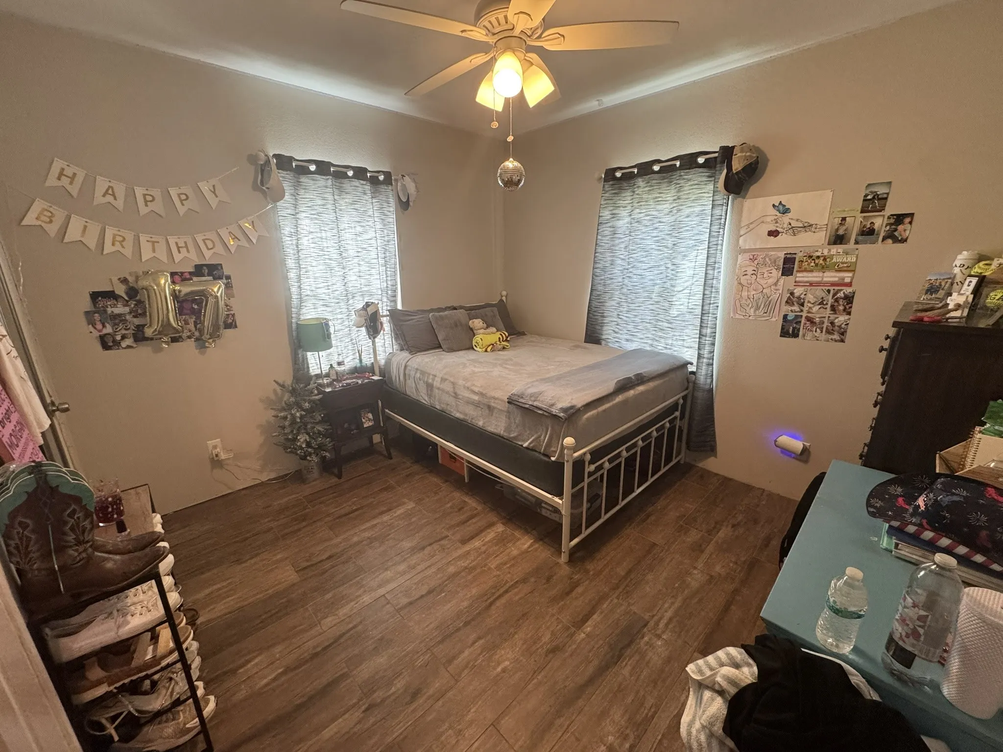 Bedroom with dark wood finished floors and ceiling fan