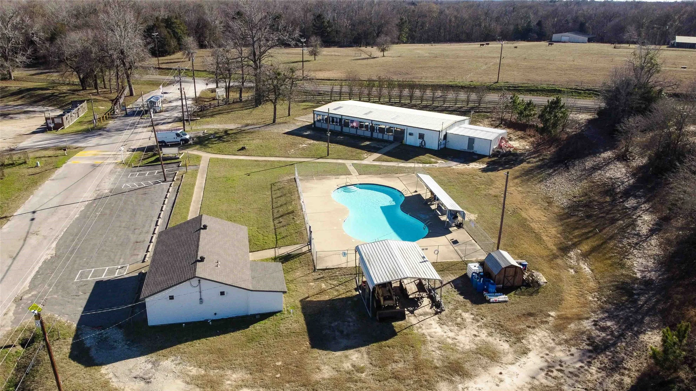 View of community pool, office pavilion, restroom and shower facility.