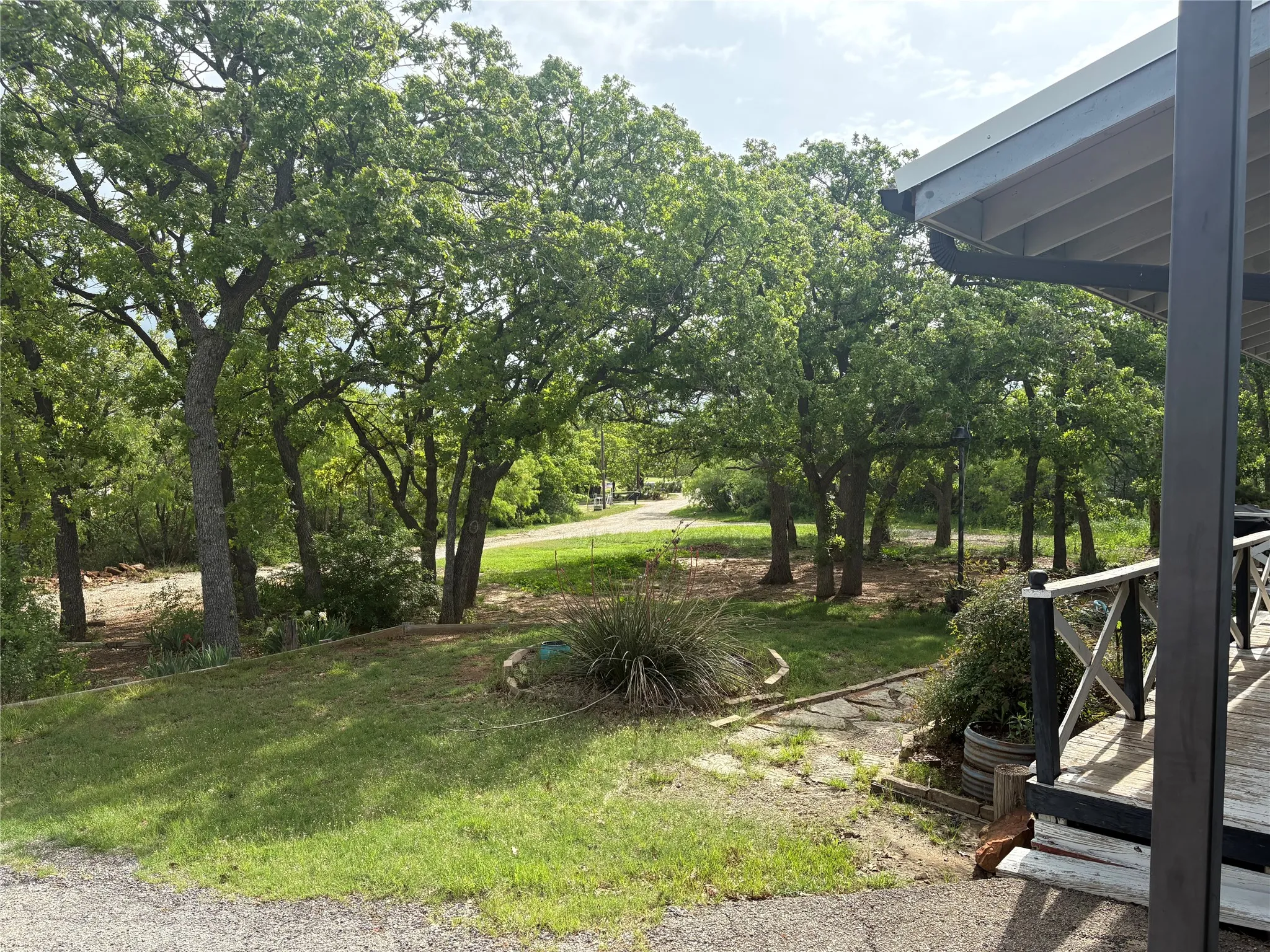 The property features a spacious yard with mature trees and a substantial lawn area