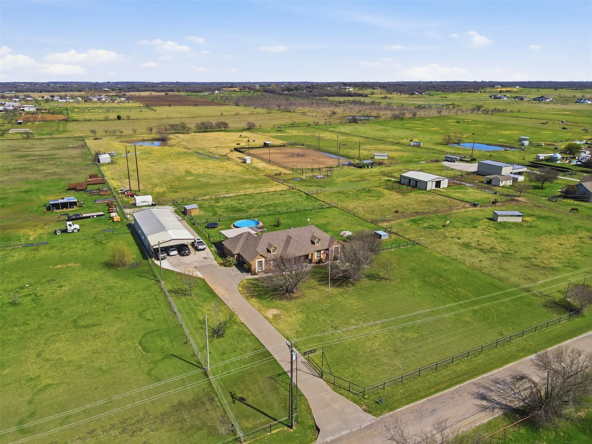 Showing aerial view of 5 acre tract with complete pipe fencing. Cross fencing for yard and dug run. Back acreage split for animals with nice size pond.