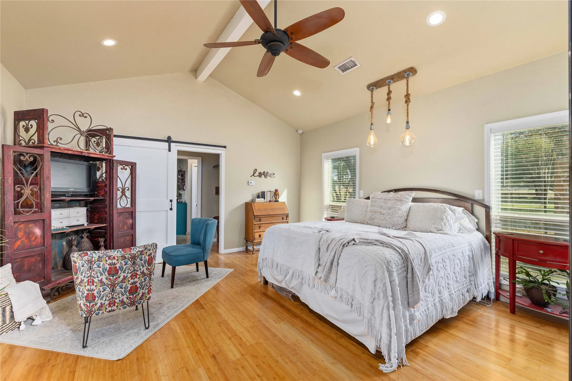 Bedroom featuring a barn door, recessed lighting, light wood finished floors, and ceiling fan