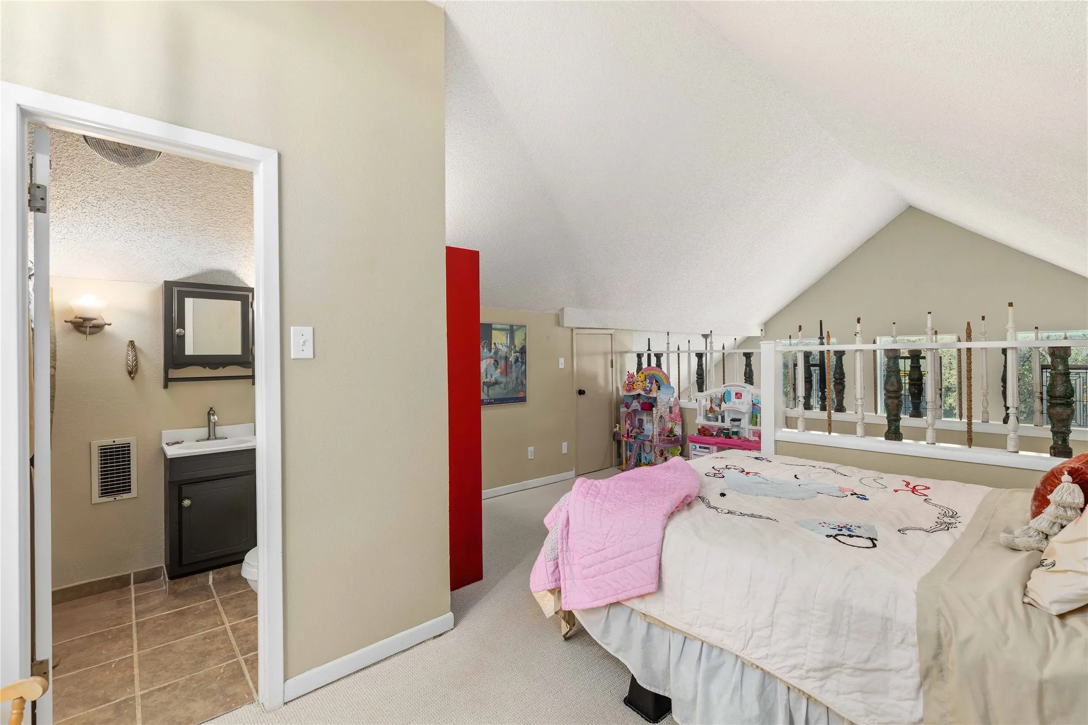 Bedroom featuring connected bathroom and light carpet