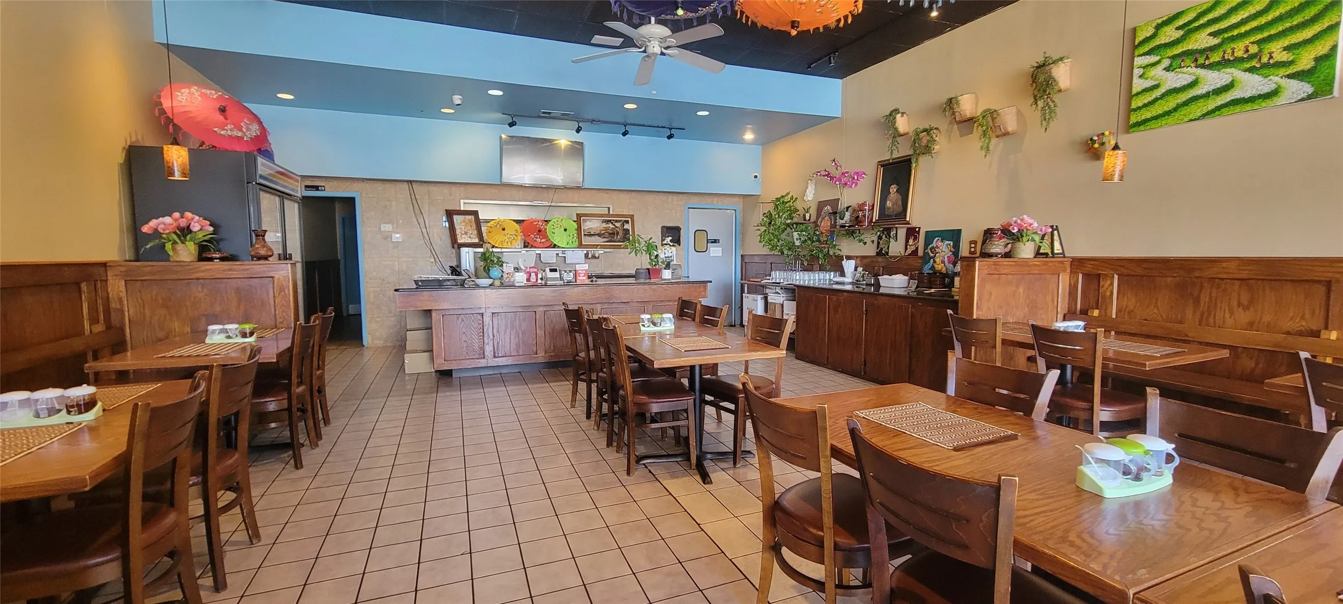 Dining area featuring light tile patterned floors, ceiling fan, a high ceiling, and recessed lighting