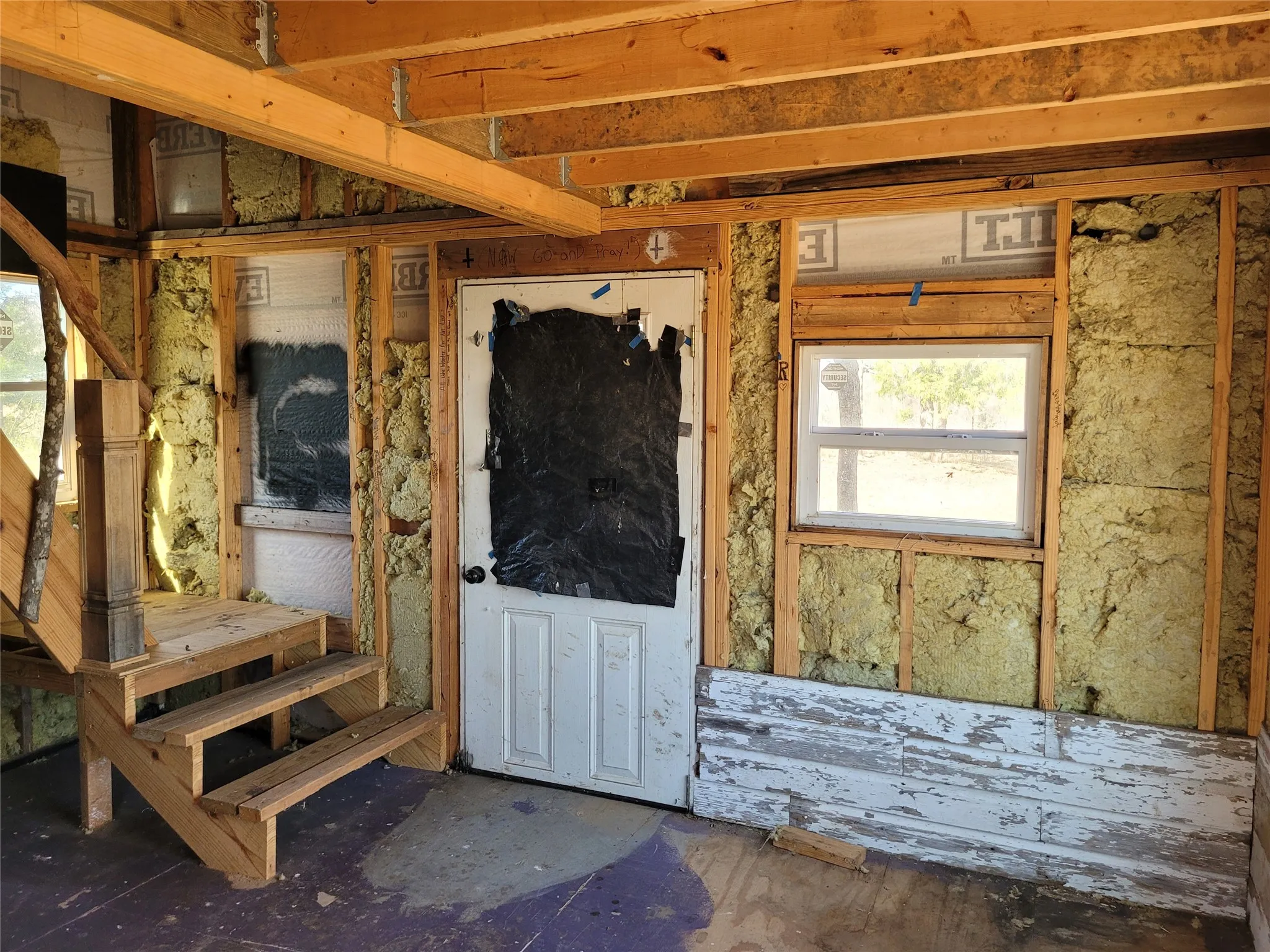 front door and stairway to unfinished loft