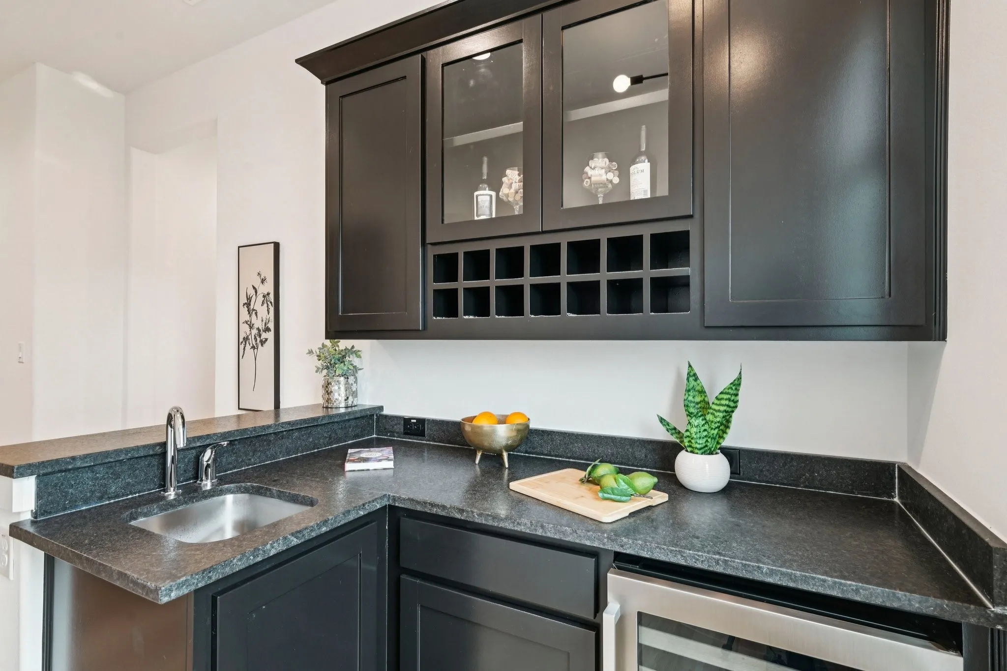 Wet bar off the media room with quartz countertops and wine refrigerator