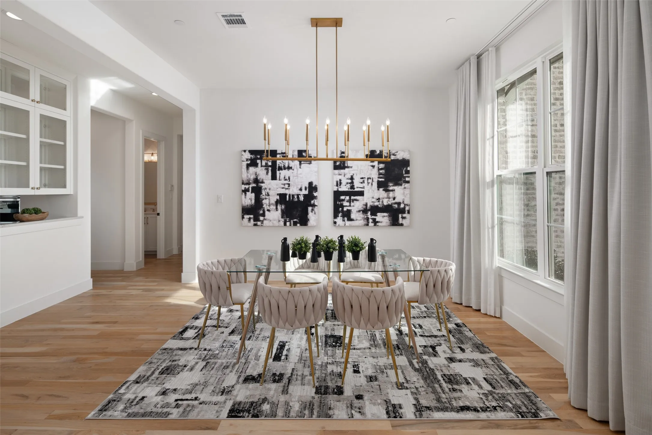 Dining room with custom made drapes and sheers that convey with home and has a dry bar which makes for easy entertaining