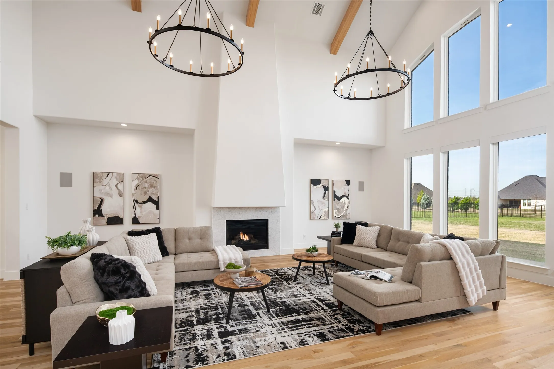 Beautiful floor to ceiling custom fireplace and 2 grand chandeliers.