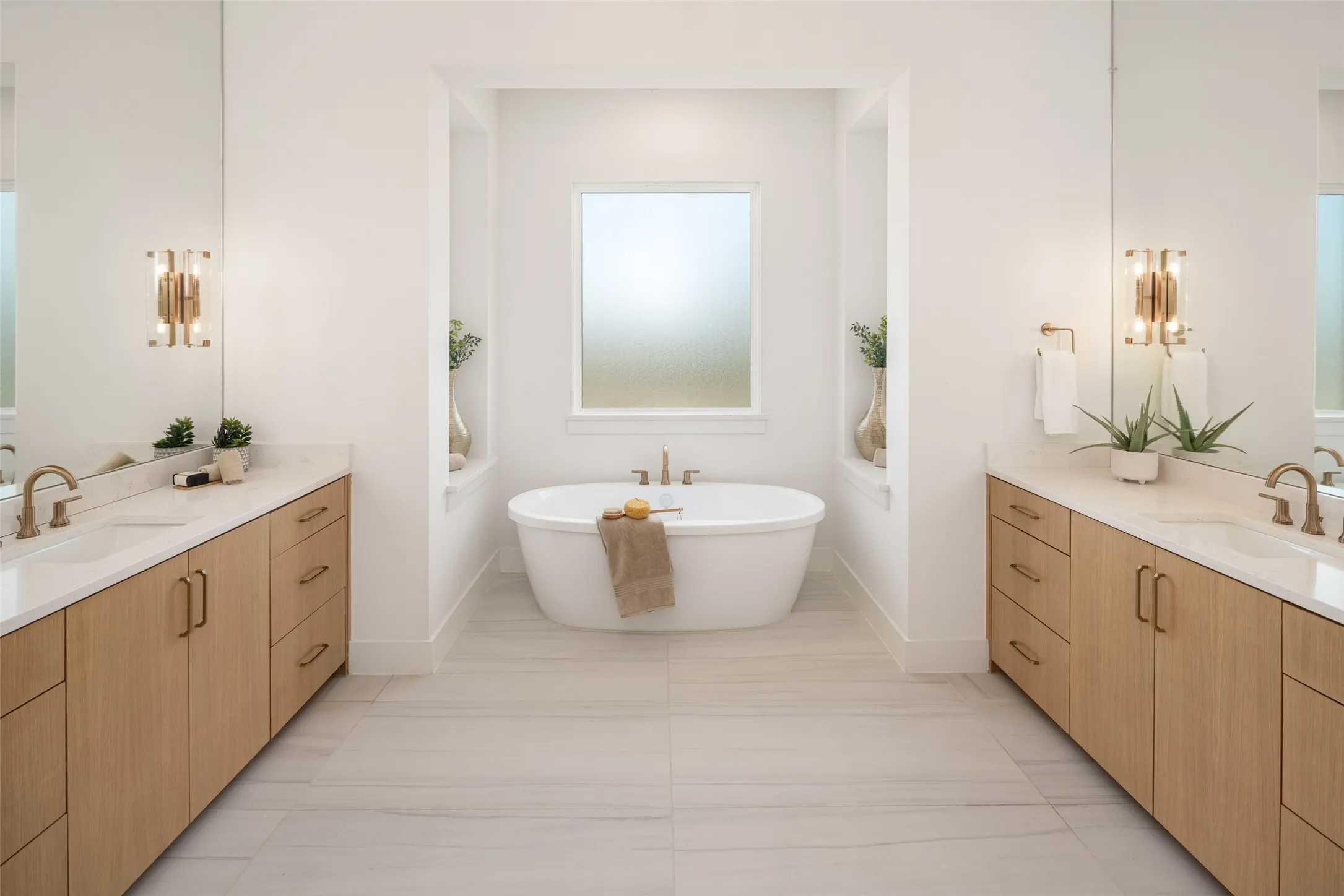 Dual vanities and large soaking tub.  Obscure glass that ensures privacy but lets the natural light filter in
