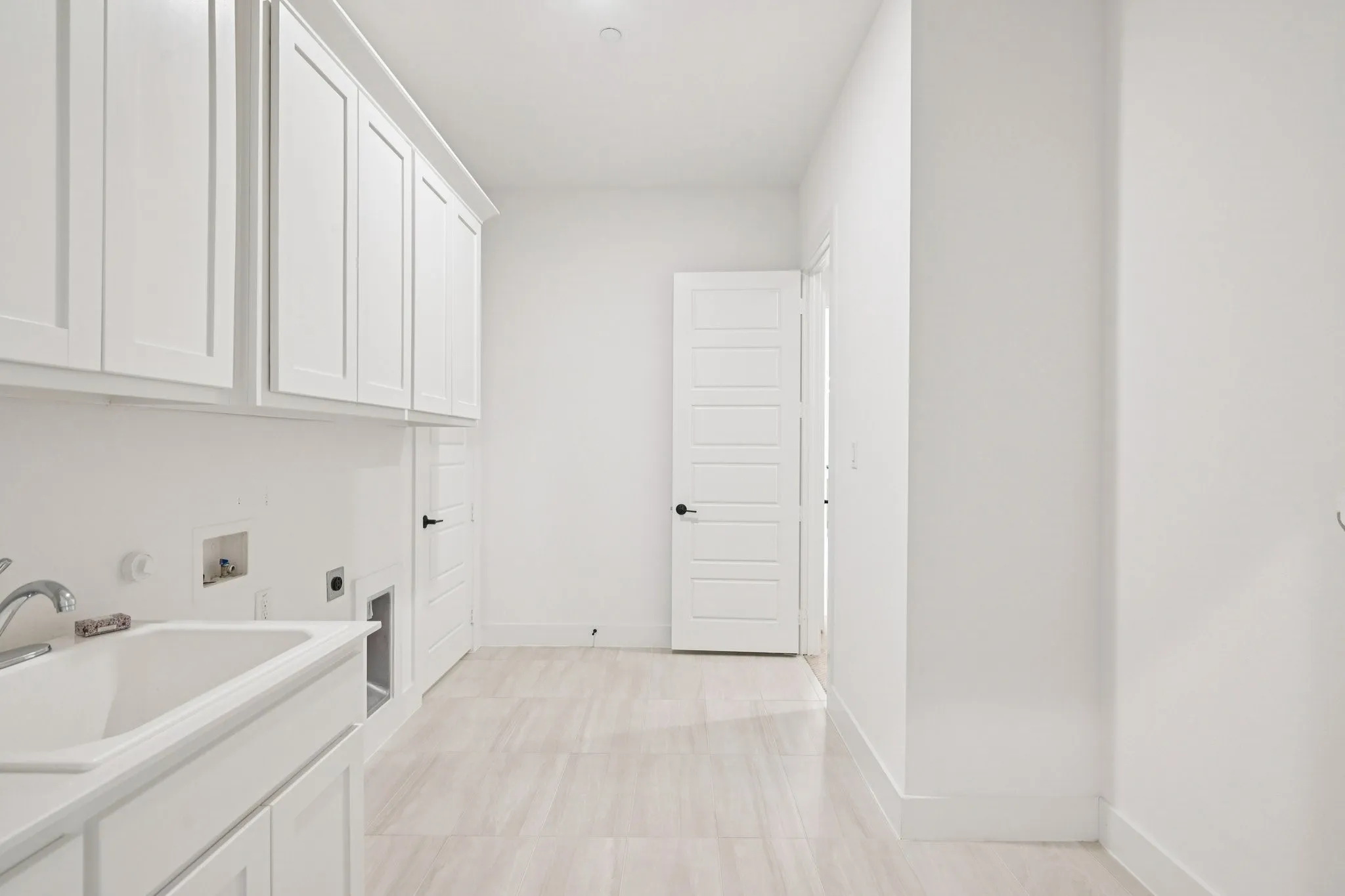 Huge laundry room with sink and built-in cabinetry.  Plenty of room for another refrigerator and freezer.  Also a great storage closet