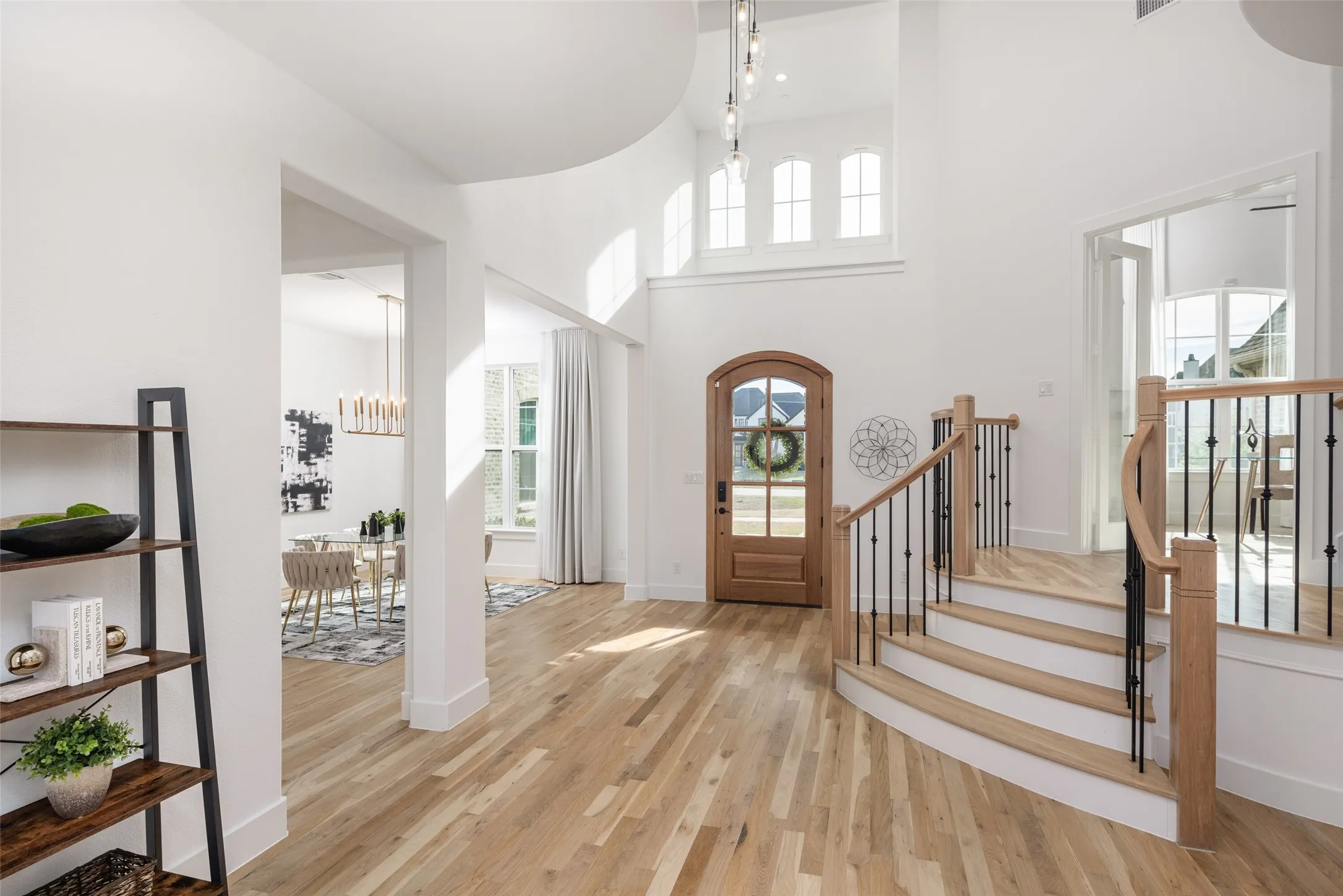 Stunning light and open vaulted entryway that showcases the beautiful white oak flooring and staircase