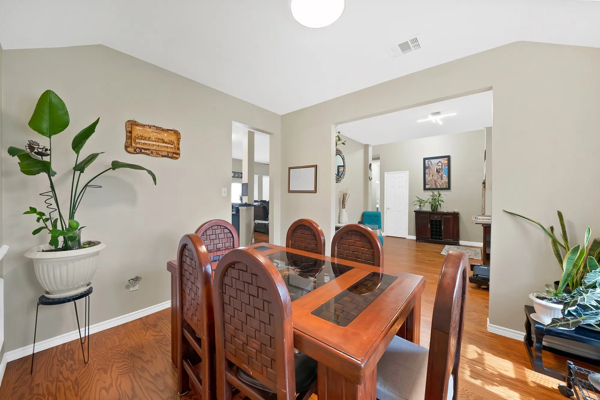 Dining space with lofted ceiling and wood finished floors