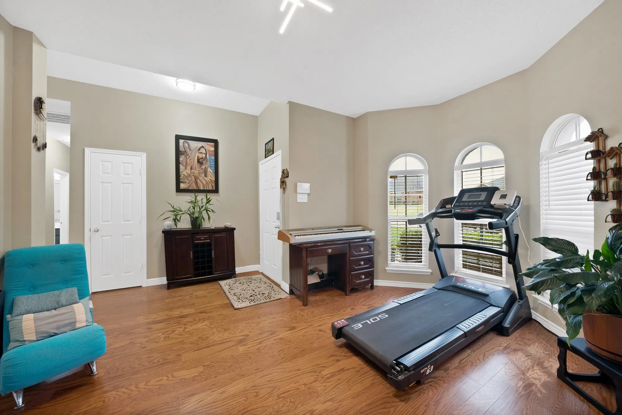 Exercise area featuring baseboards and wood finished floors