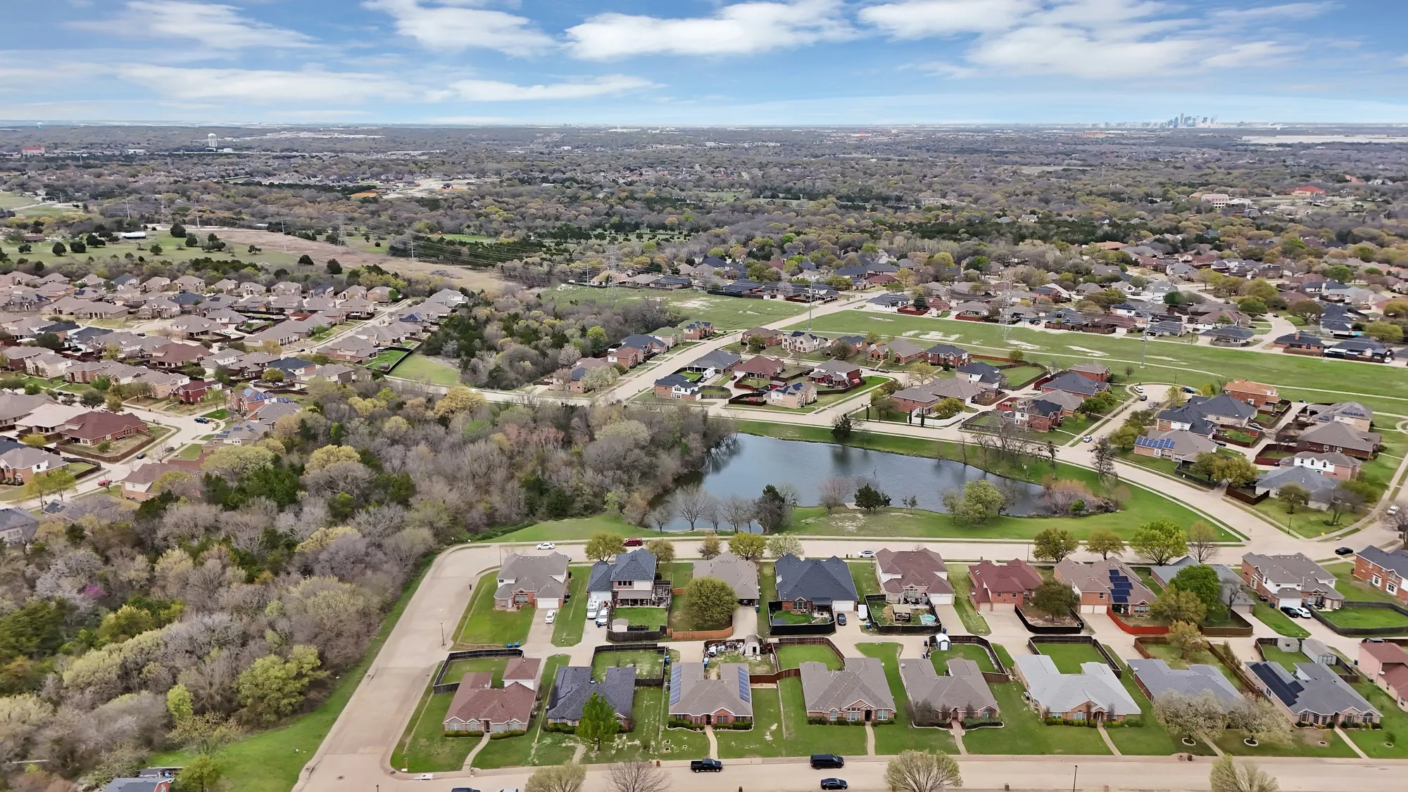 Aerial perspective of suburban area featuring a large body of water