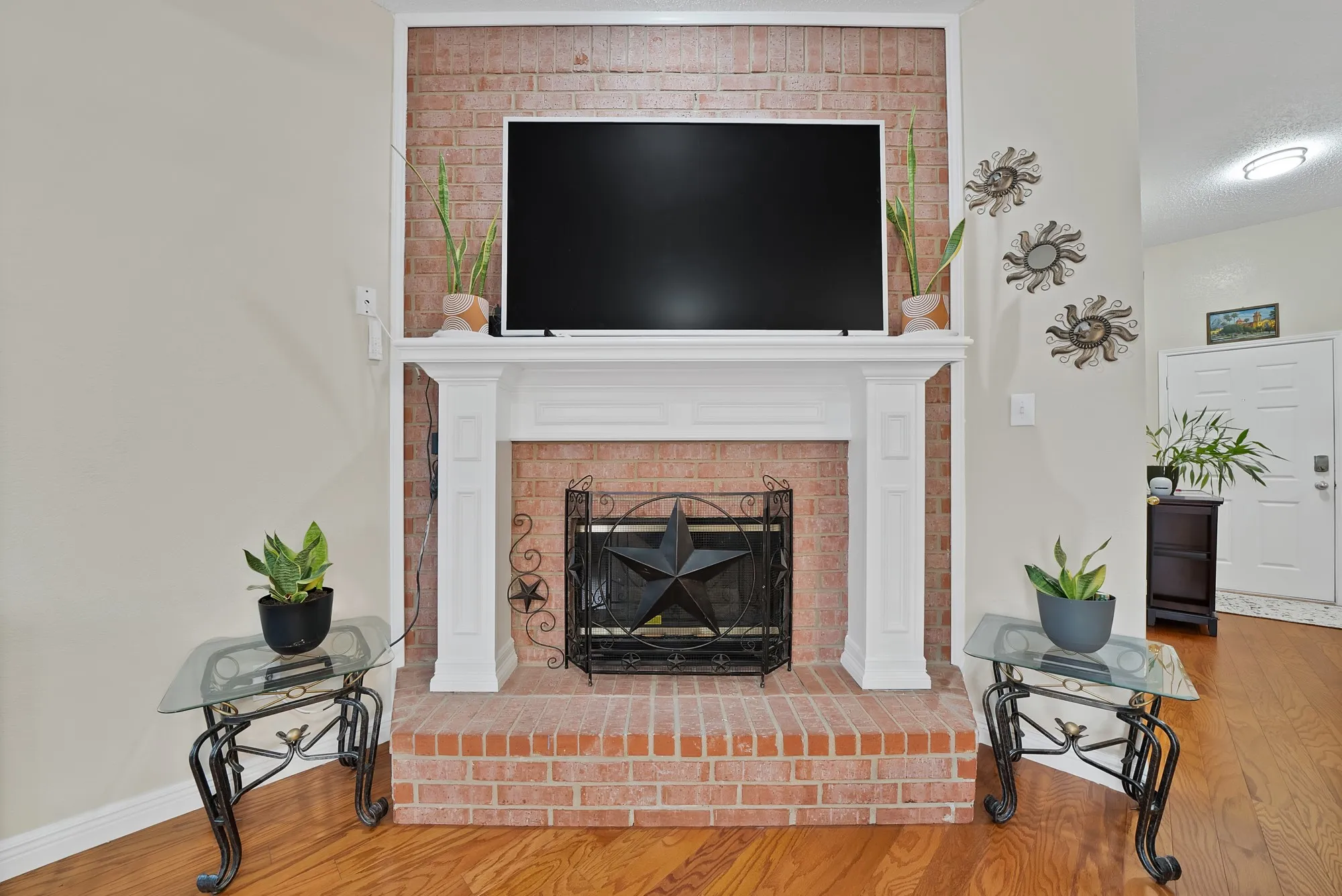 Detailed view of wood finished floors and a fireplace