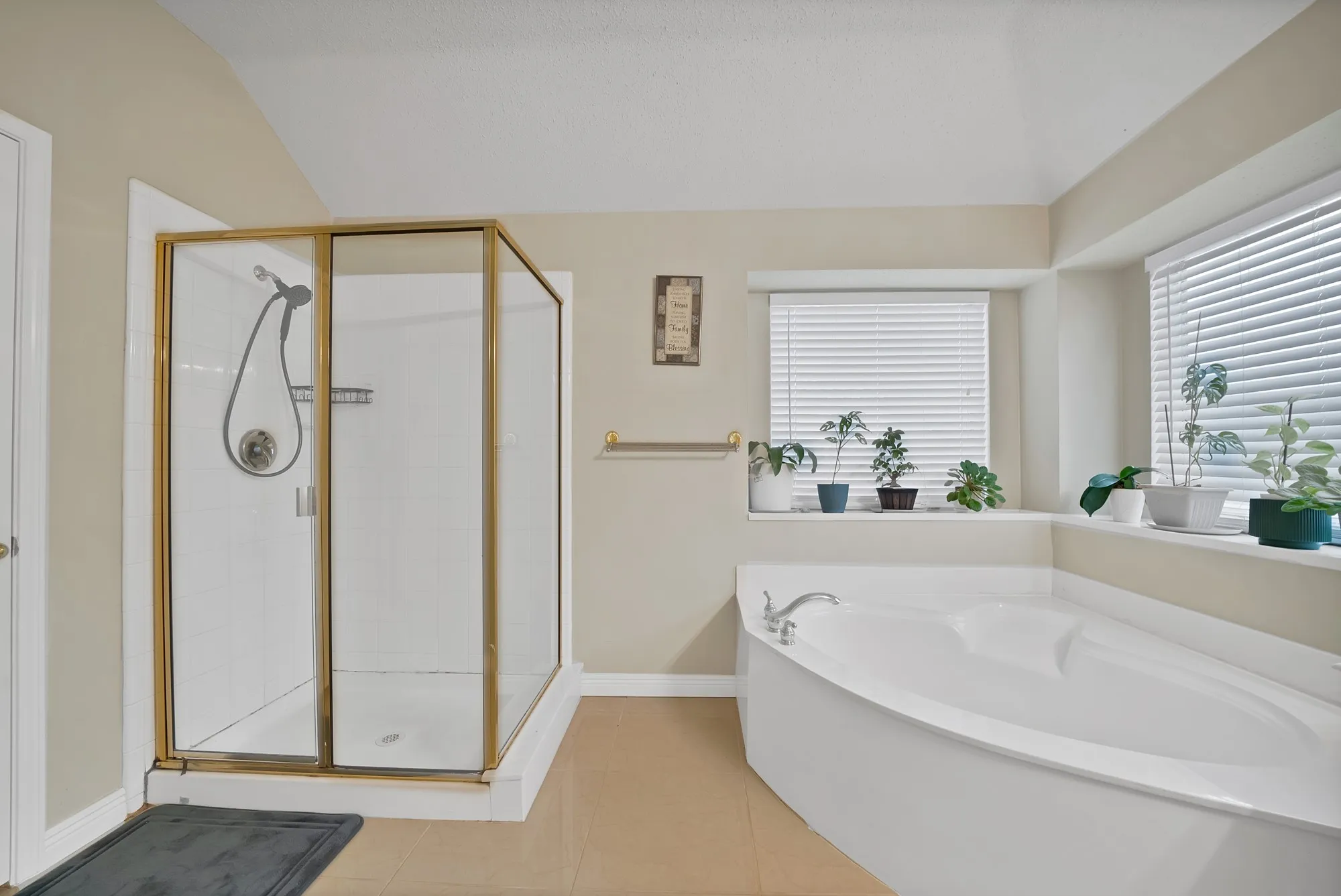 Bathroom with a garden tub, a stall shower, and light tile patterned floors