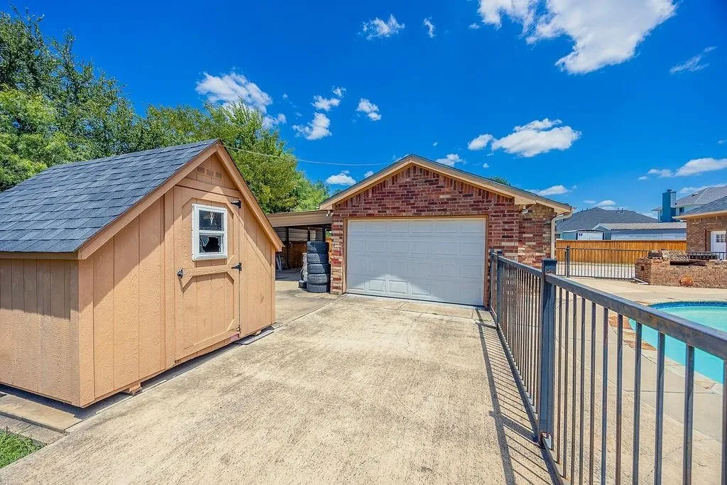 Detached garage featuring a storage shed