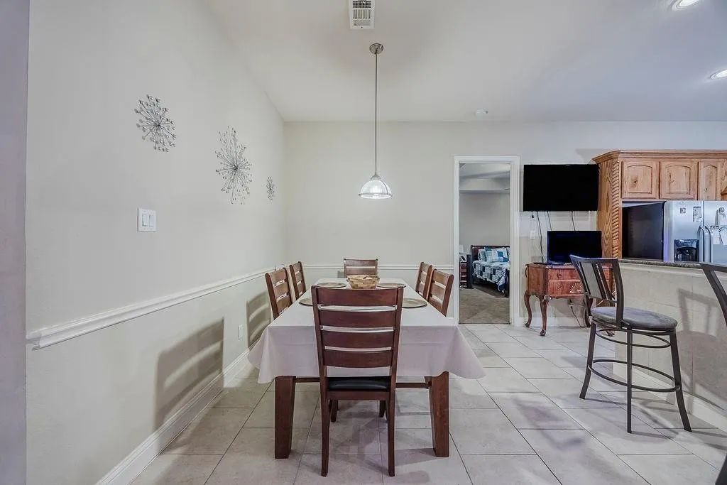 Breakfast area featuring light tile patterned flooring and baseboards