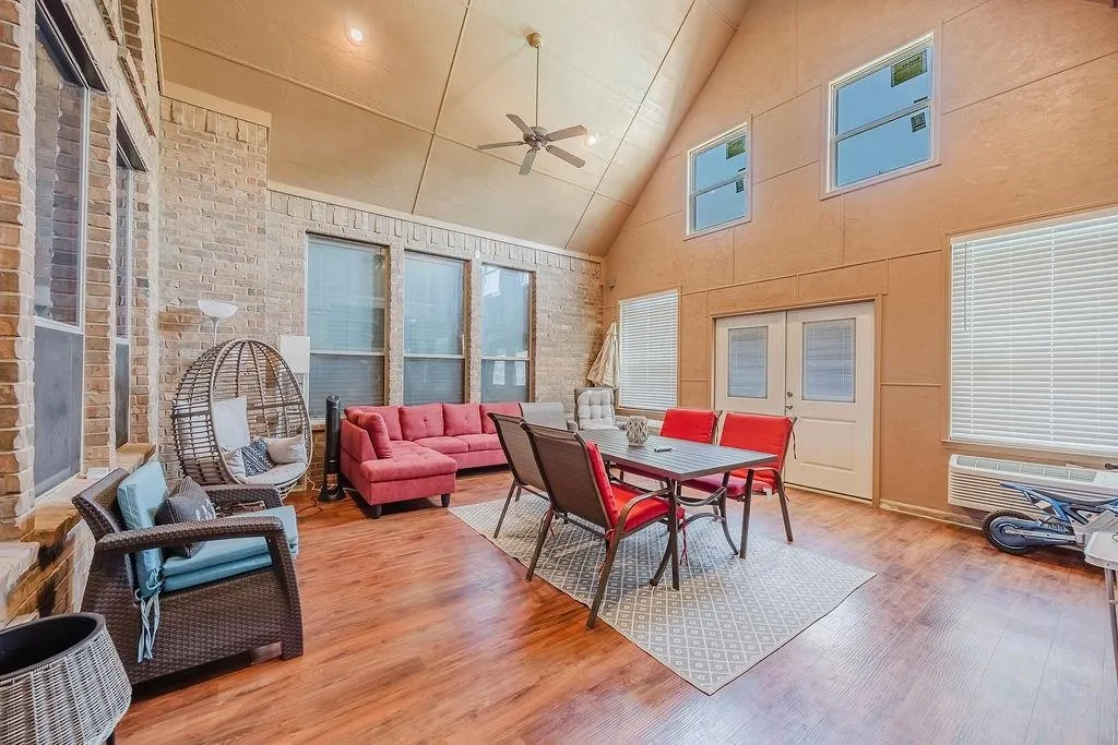 Enclosed patio with AC and French doors leading to the pool area.