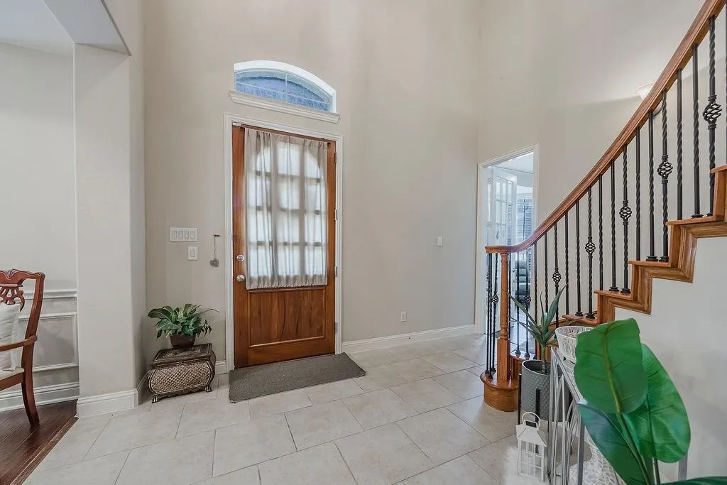 Entrance foyer featuring a high ceiling and light tile patterned floors