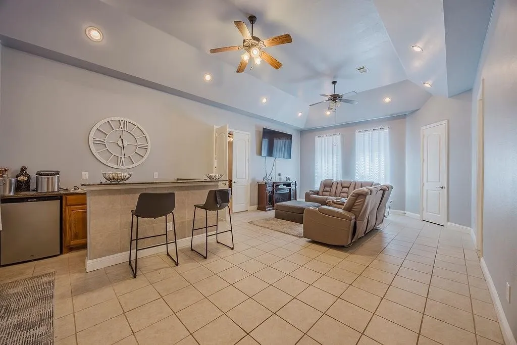 Game room on first floor adjacent to the enclosed patio. Includes bar area for entertaining and a full bath.