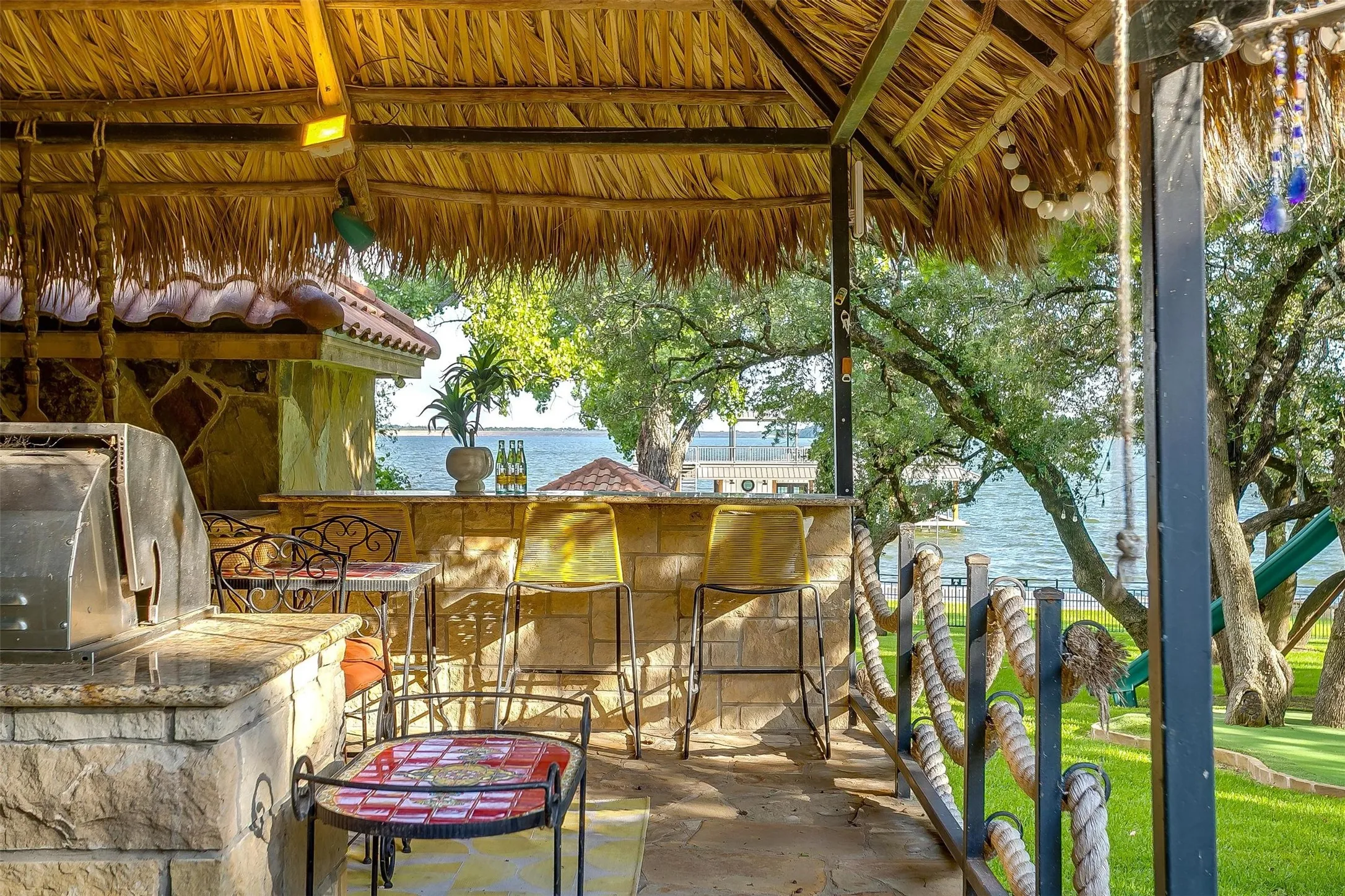 This outdoor palapa located by the pool at the primary residence includes a grill, bar, and space for hosting.