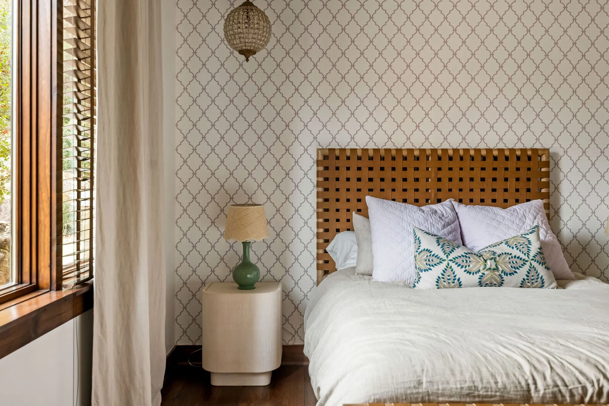 This downstairs guest bedroom allows its own sense of charm with its unique wall prints and space.