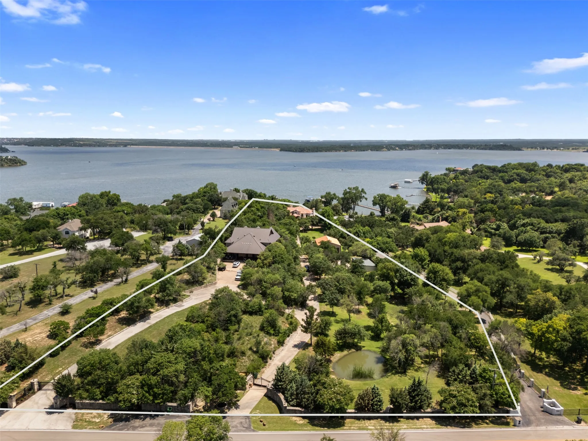 9930 Boat Club Road includes a stunning primary residence, private dock, Guest Cottage, Hill Lodge, two shops, and a pond. Enjoy the scenic views of Eagle Mountain Lake!