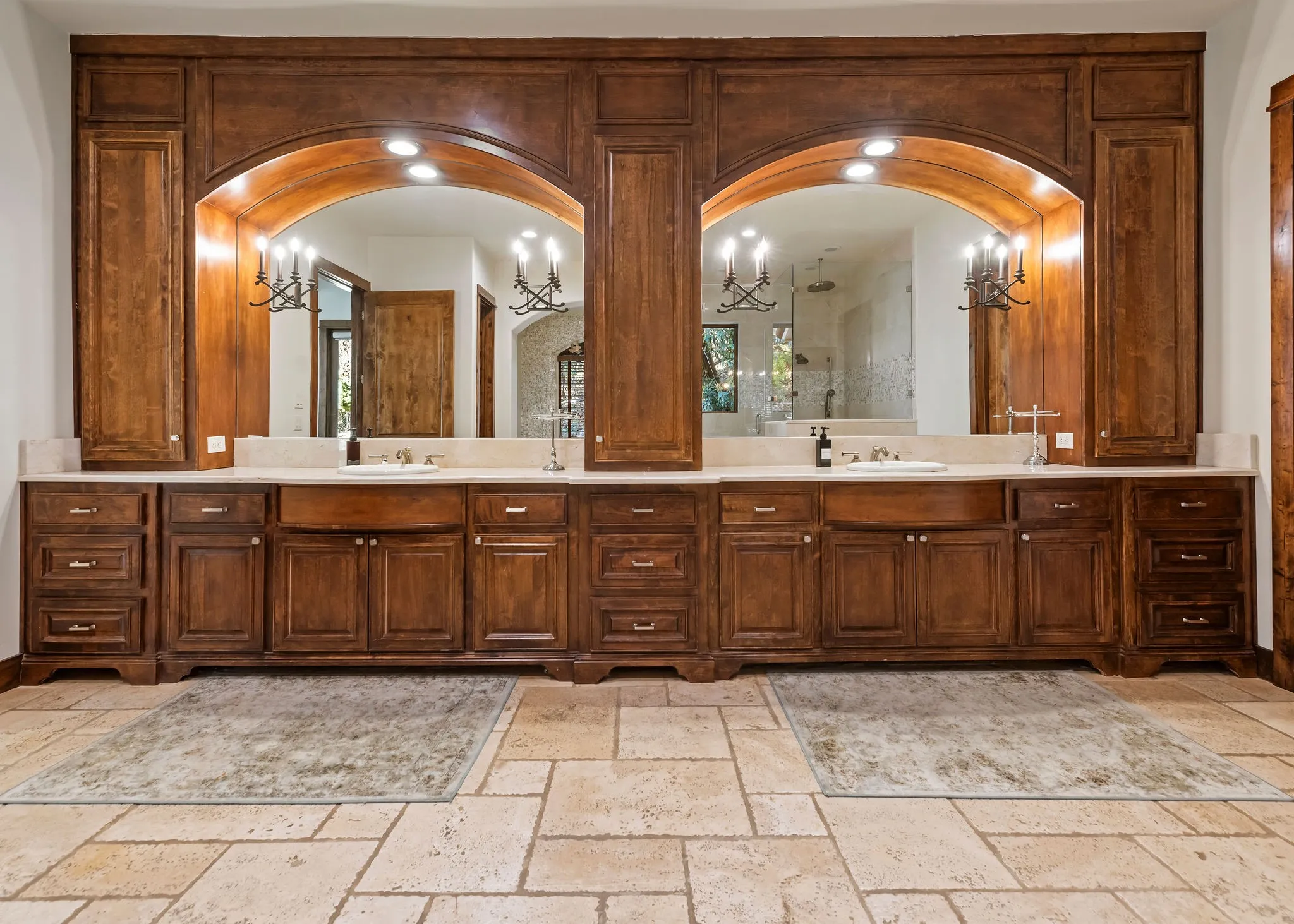 On the other side of the primary bathroom you are greeted with dark wood cabinetry, his and her sinks with two large mirrors, and ample space!