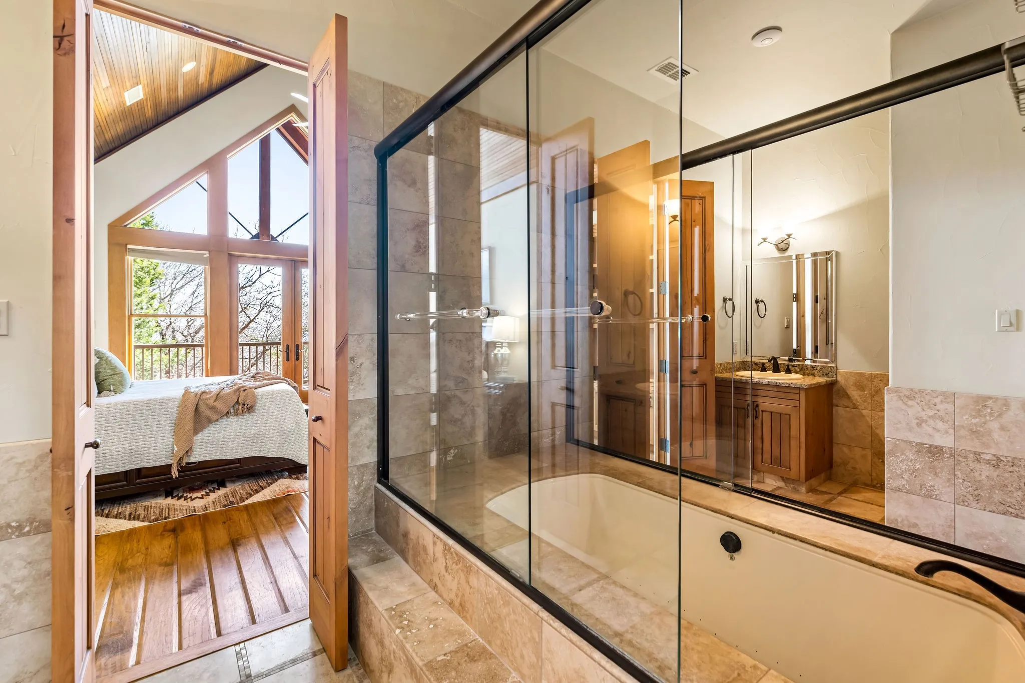 3 bathrooms at Hill Lodge all include a glassed in shower and bathtub, sinks, and closets.
