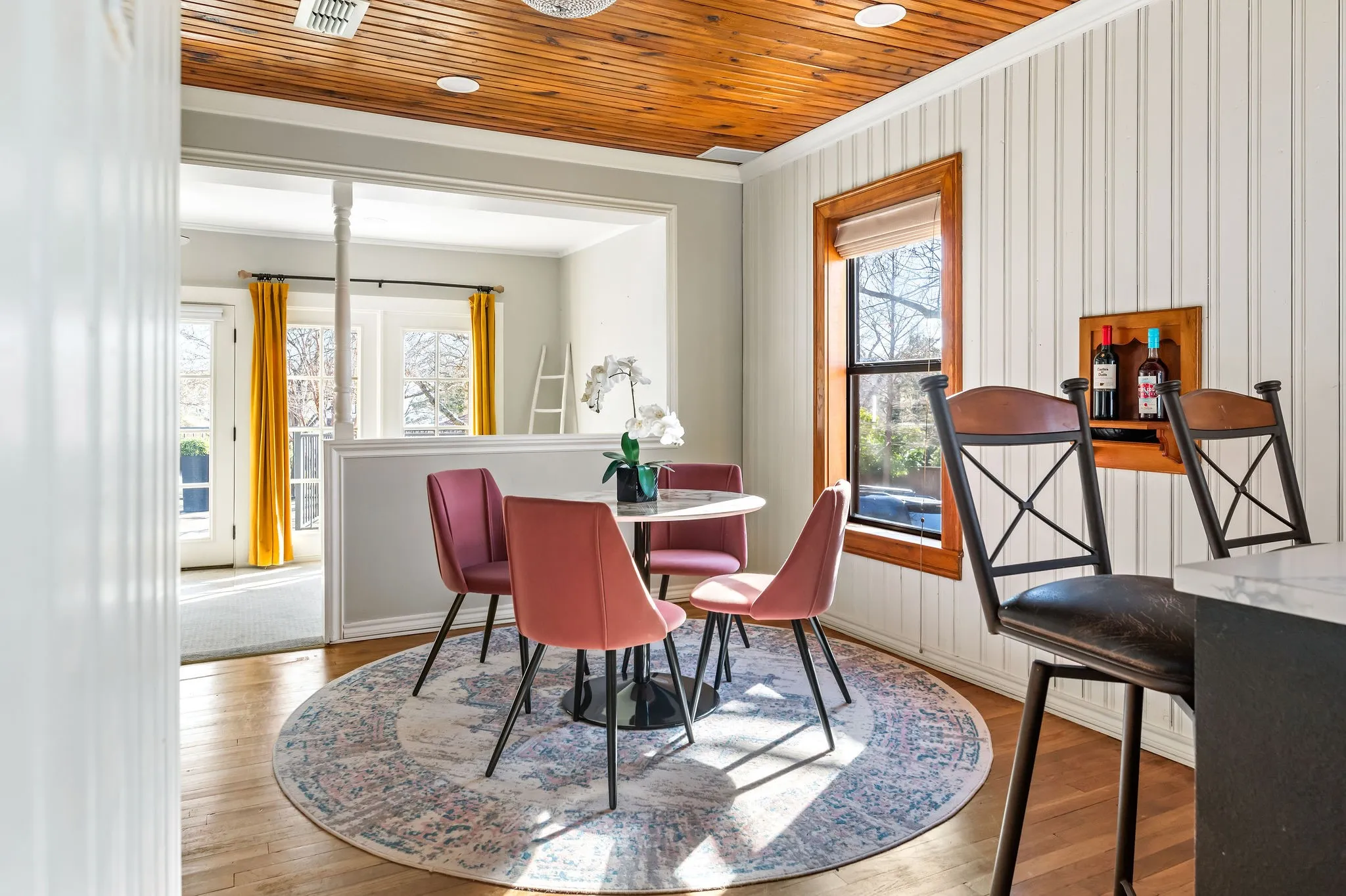 The Guest Cottage dining room overlooks the living room with immaculate natural lighting.
