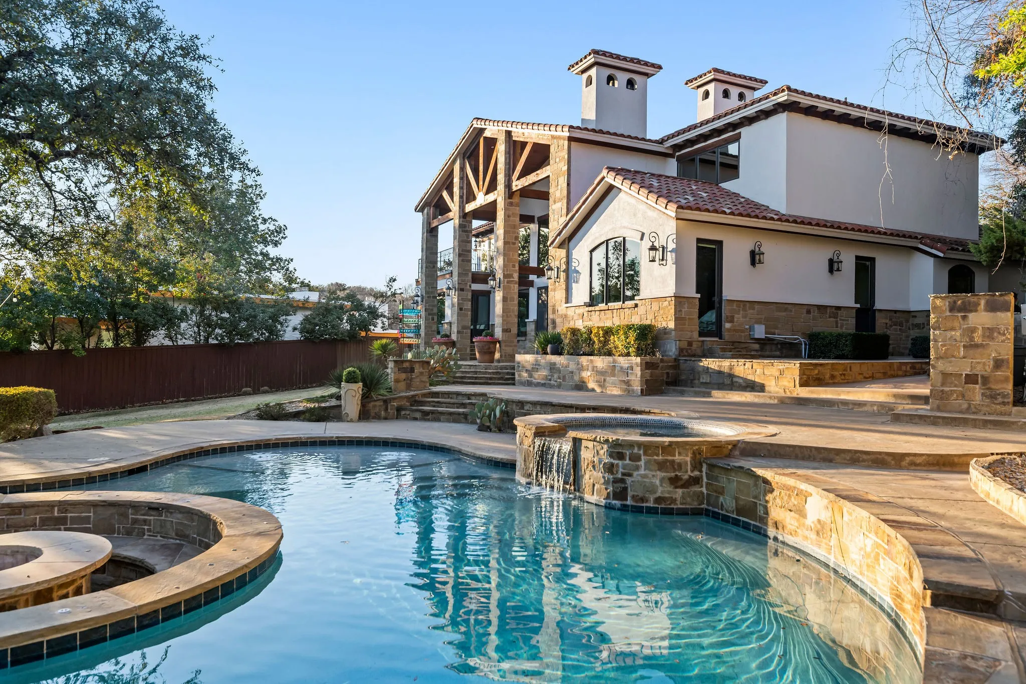 Enjoy a refreshing swim at the main house's stunning pool, nestled in a peaceful setting.