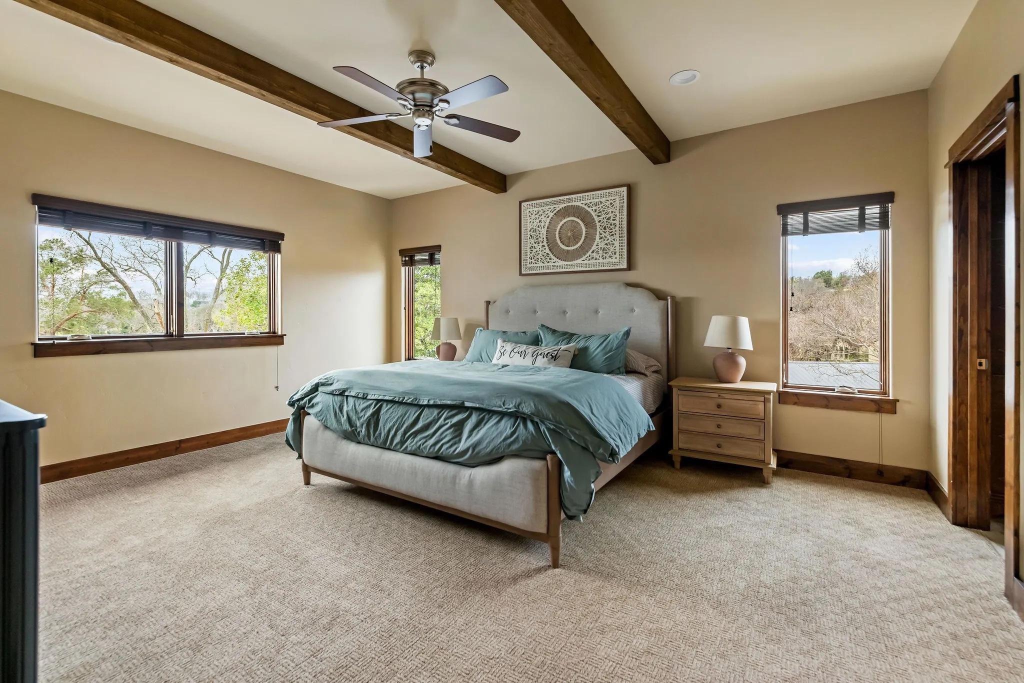 This upstairs bedroom with en suite in the main residence brings in all the natural window lighting with the elevated views outside!
