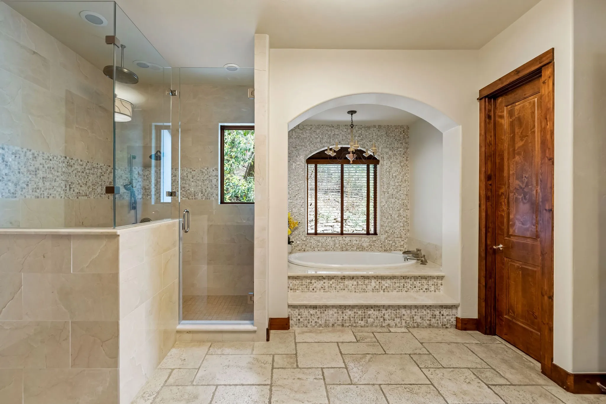The primary bathroom in the main house includes a walk in shower and a luxury bath tub!
