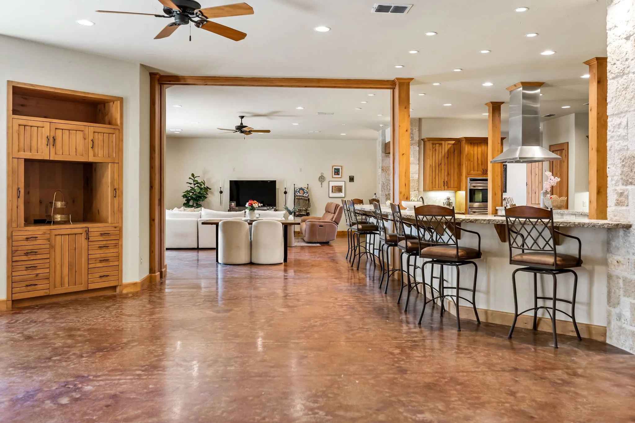 Hill Lodge features two spacious living areas that flow seamlessly into a large, open kitchen and bar seating.
