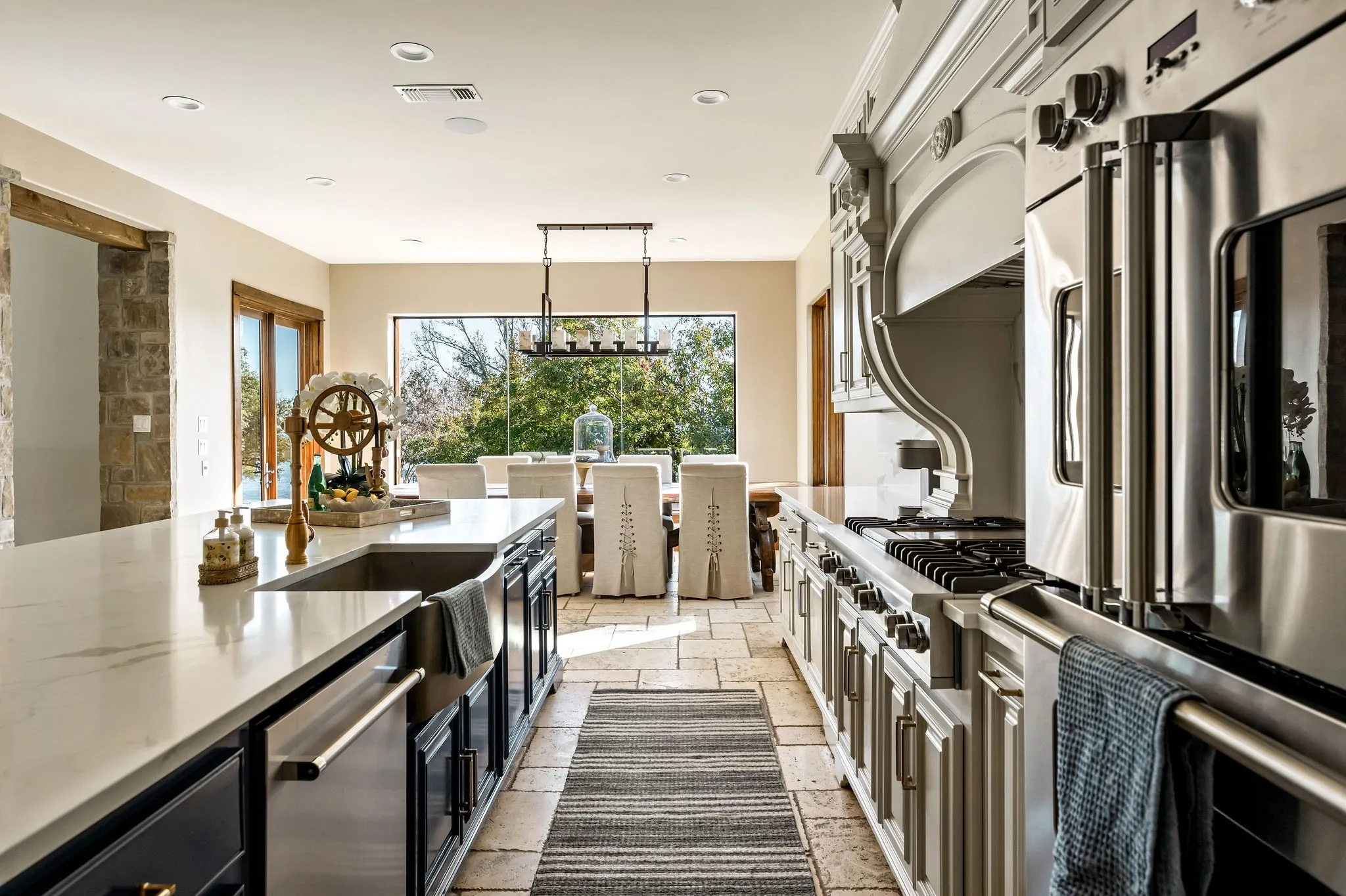 The main house kitchen offers elegant finishes, a large island, and premium appliances designed for both style and function.