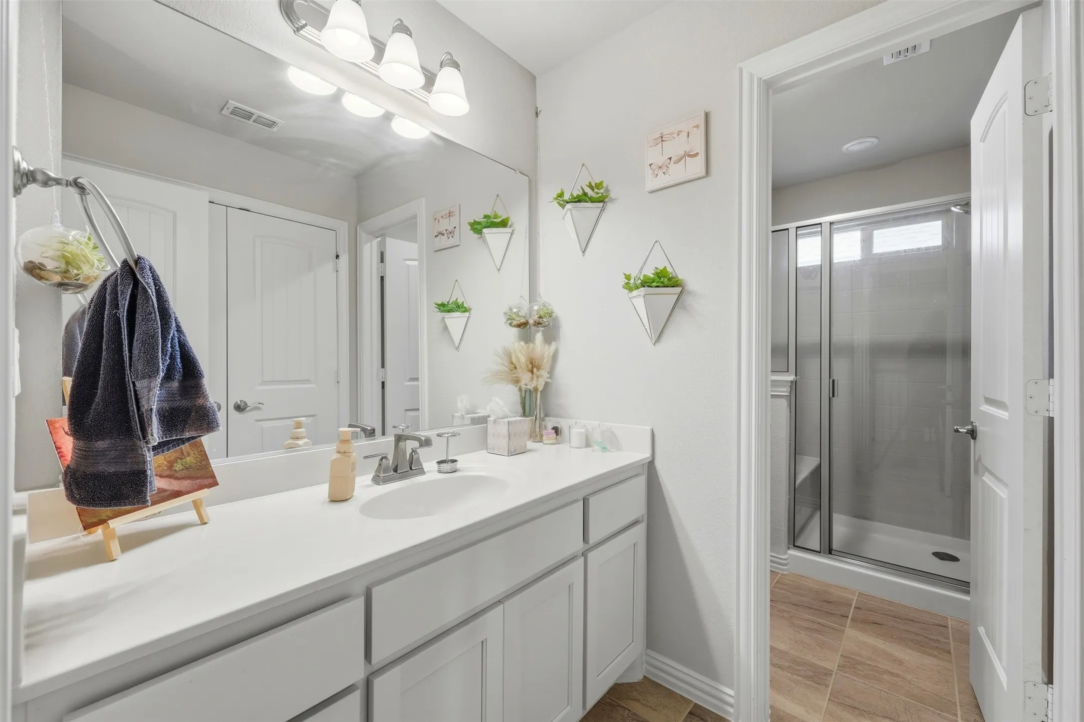 Full bath featuring vanity and a shower stall