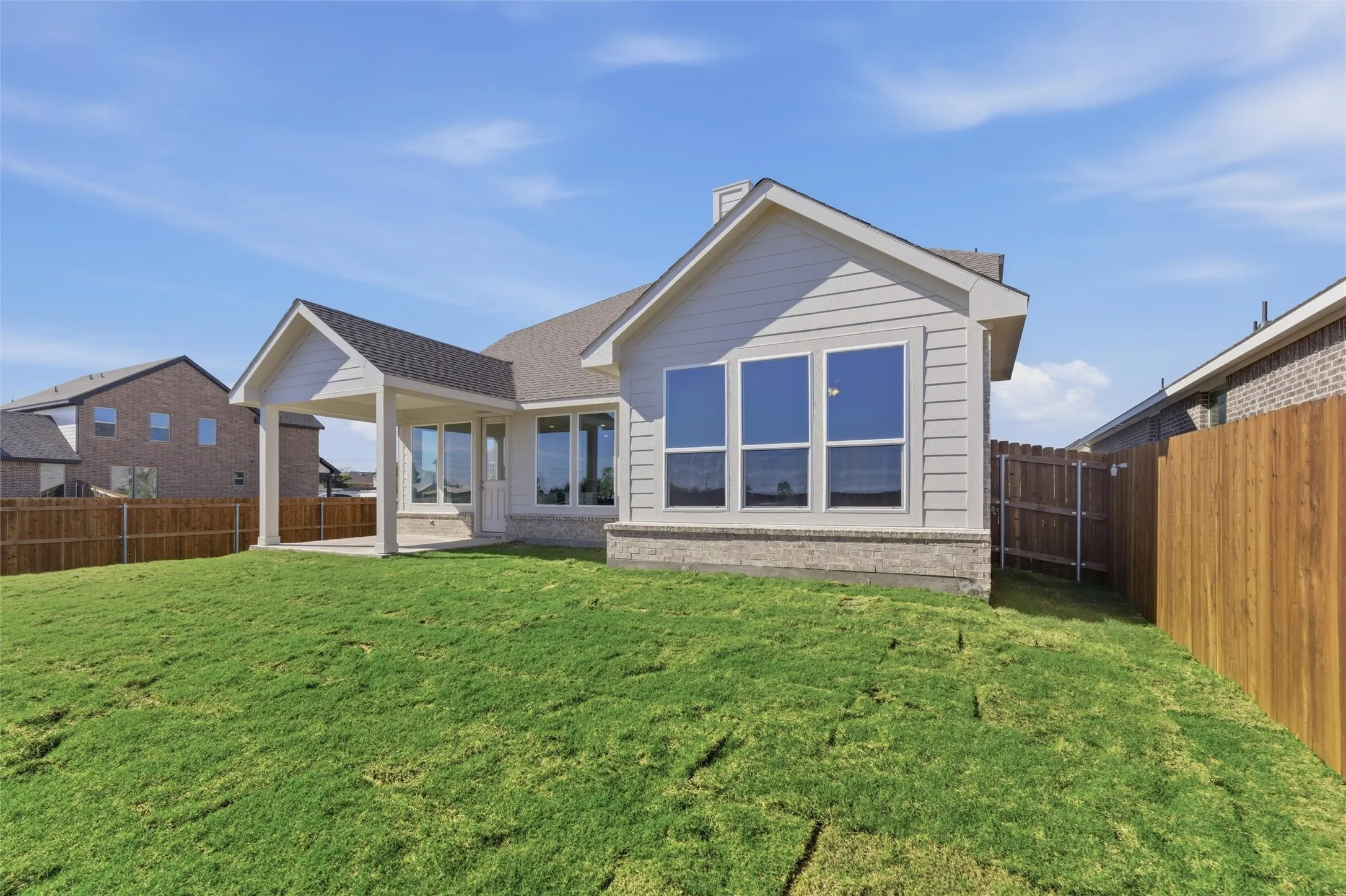 Back of property with a patio area, a fenced backyard, and a chimney