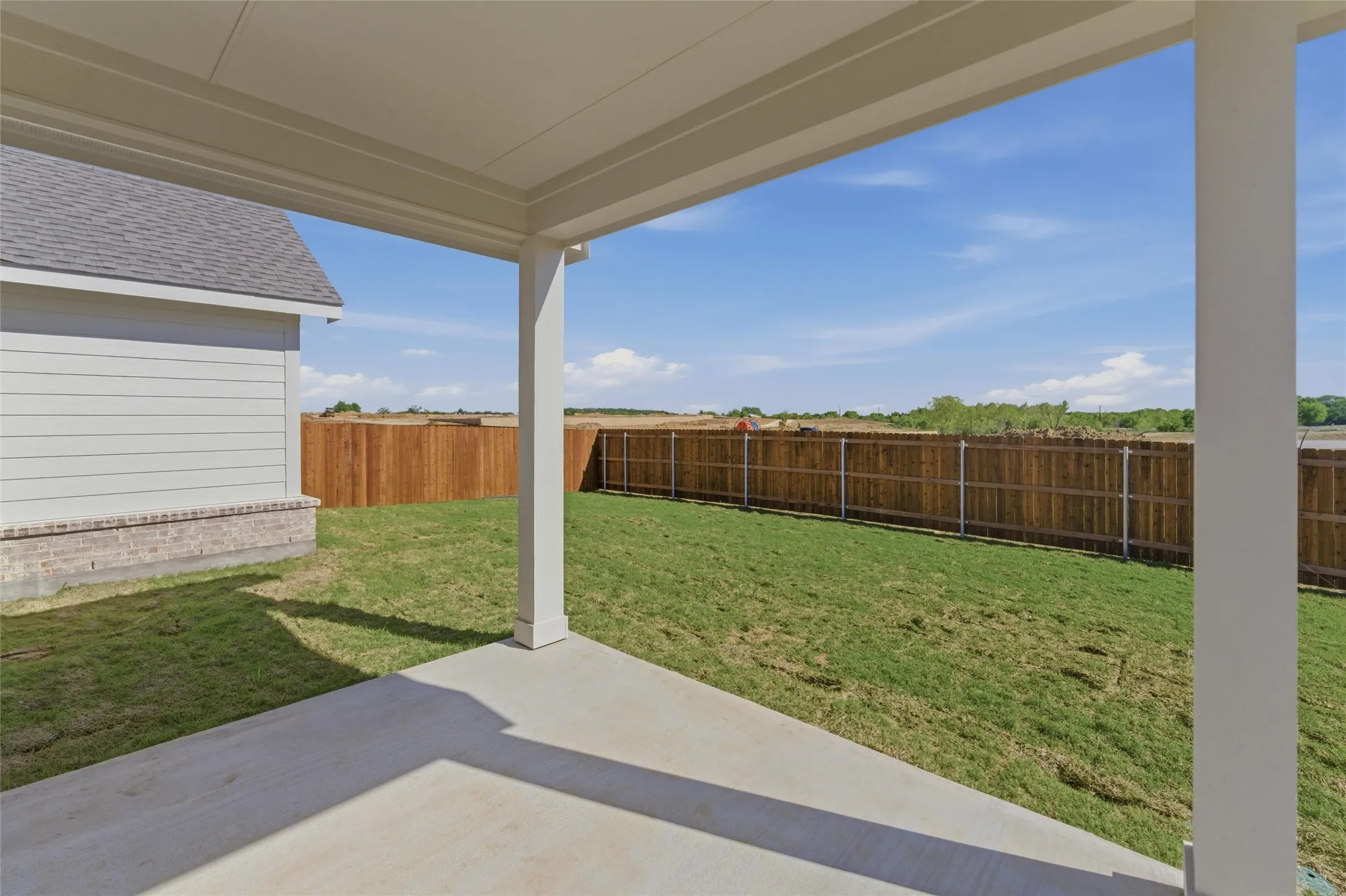 Fenced backyard featuring a patio